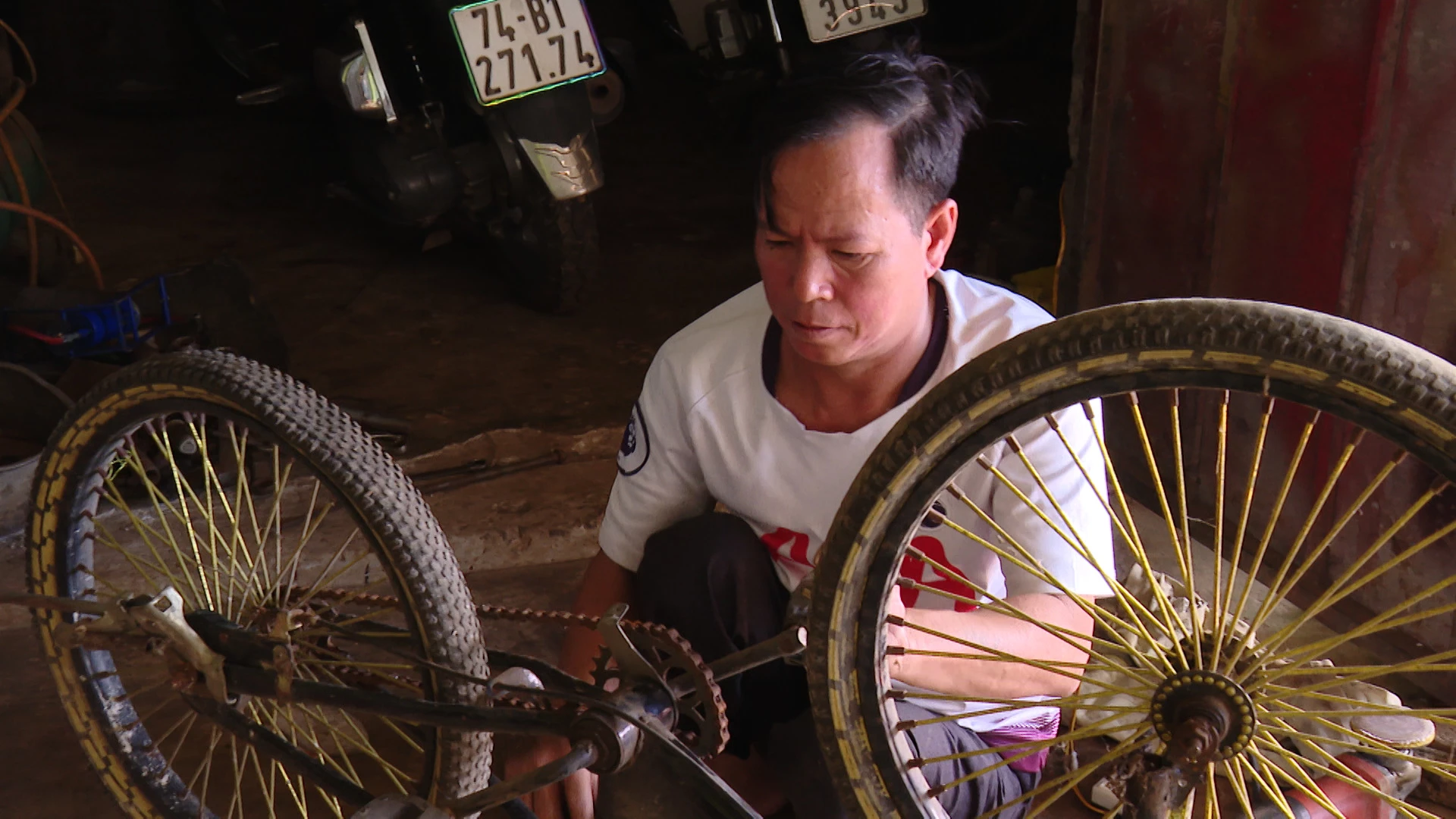 Anh Trần Trung với công việc sửa xe hằng ngày  -Ảnh: N.D