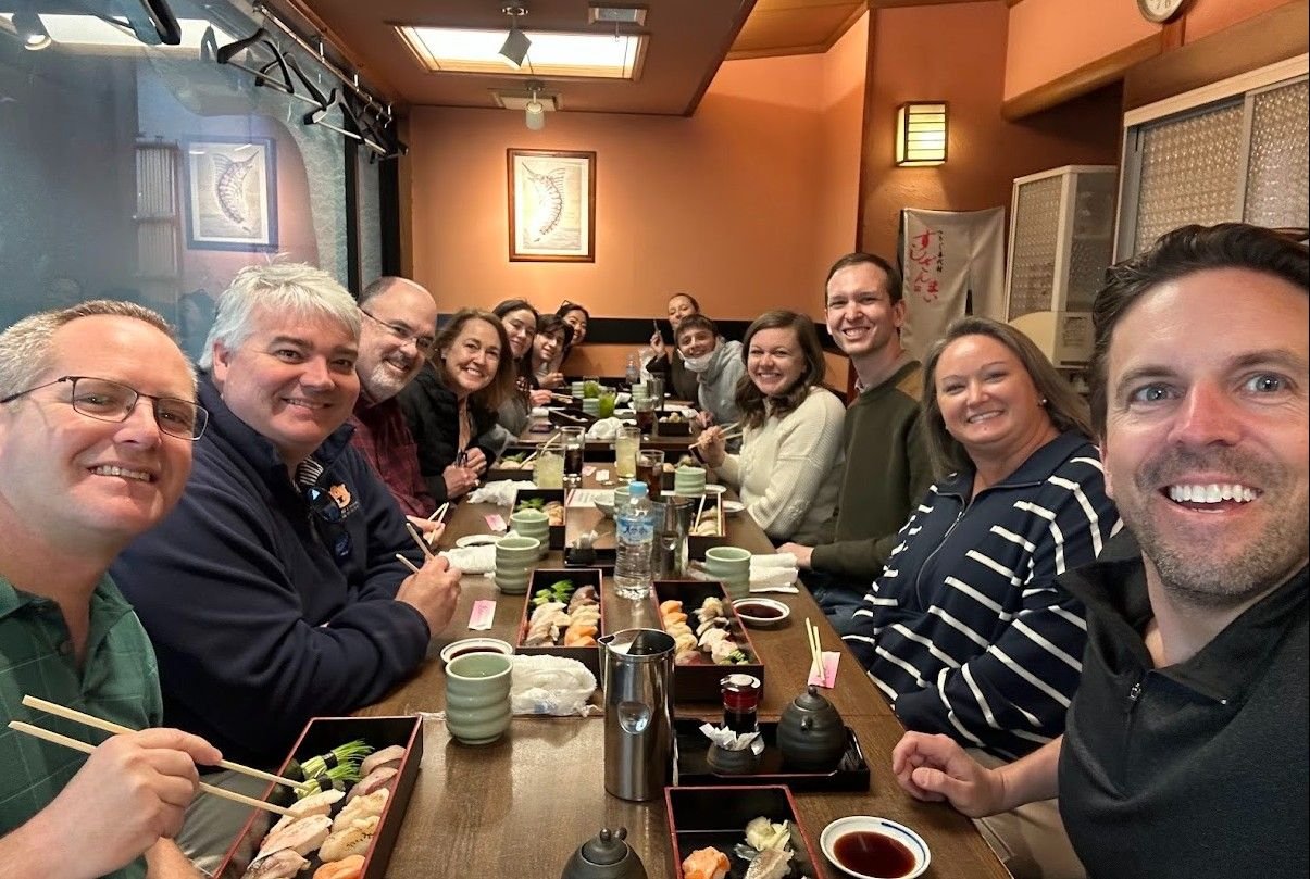 Faculty and students at a sushi dinner in Japan