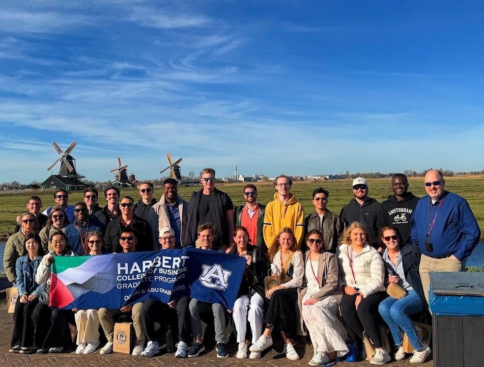 MBA students at Dutch windmills with Harbert banner