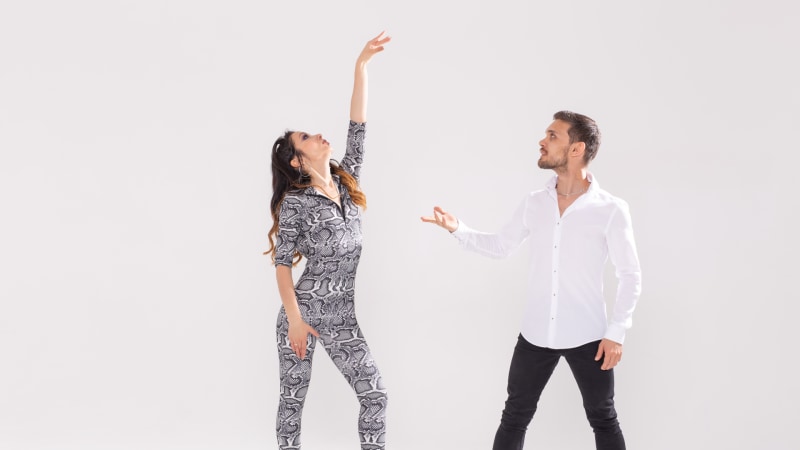 Danseurs de Salsa, Kizomba, Tango et Bachata devant un mur blanc avec de l'espace pour du texte, concept pour la danse sociale