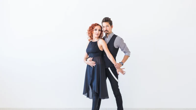 Ein Paar tanzt Bachata vor weißem Hintergrund