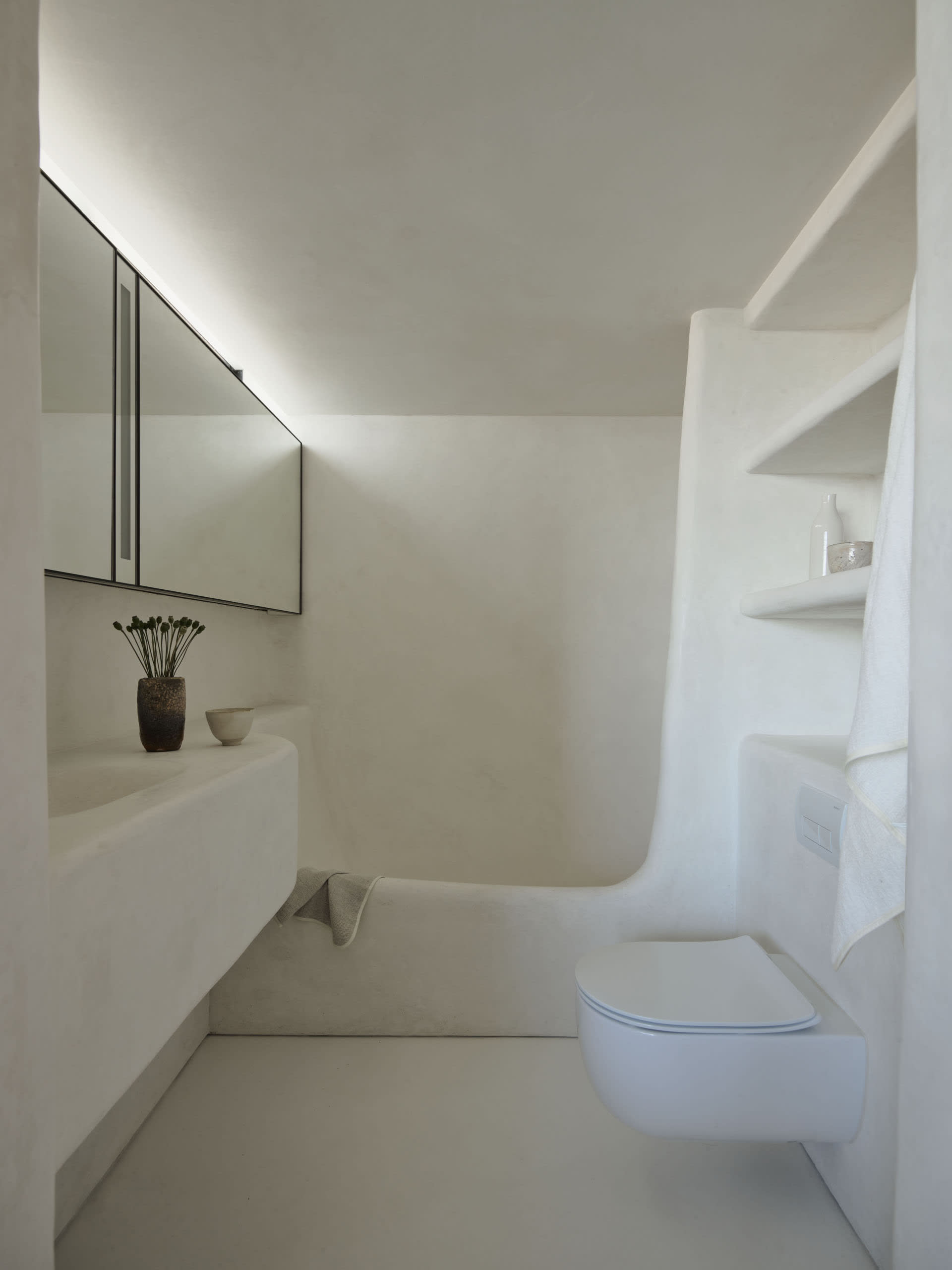 Minimalist white bathroom with seamless walls