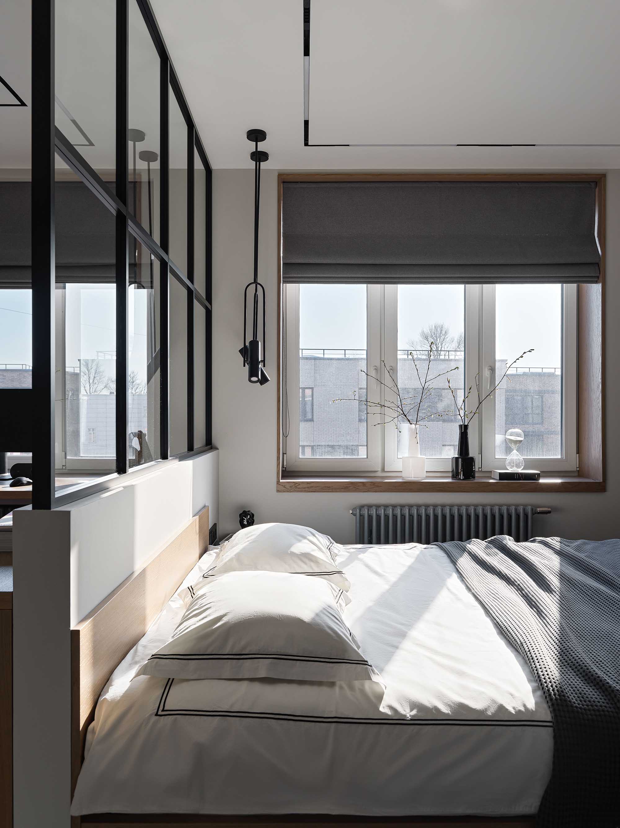 Bedroom with large energy efficient windows providing natural daylight and warmth