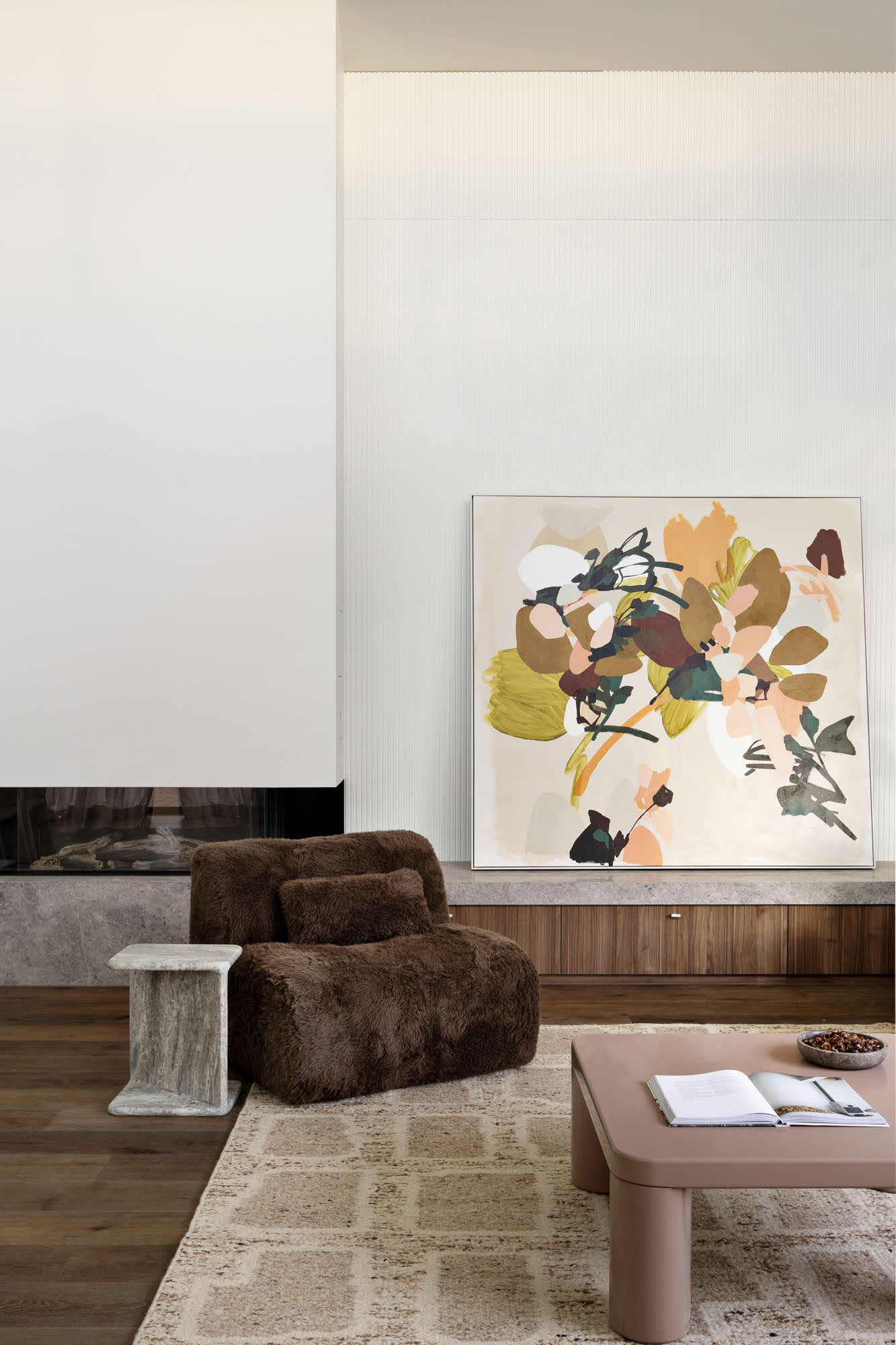 Modern living room with artistic statement wall featuring hand-painted abstract mural