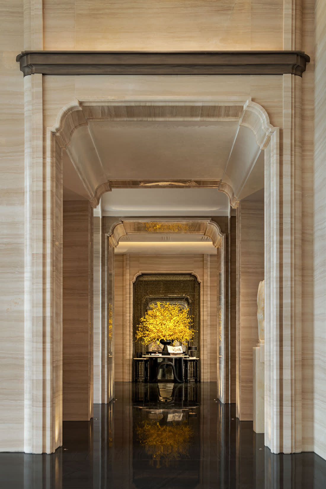 Ornate gold frame mirror in a luxurious entryway with dramatic lighting