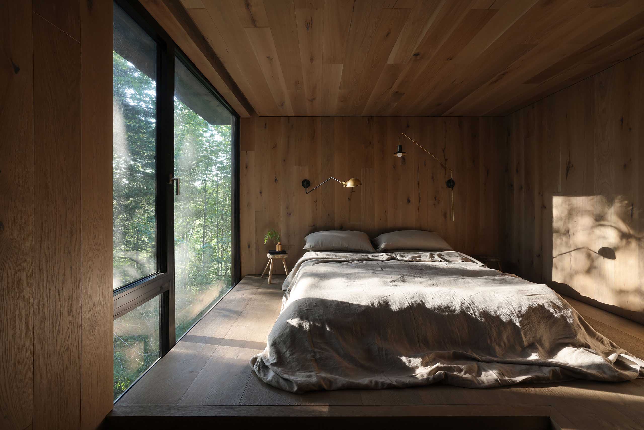 Bedroom with organic textures including wood furniture and linen bedding