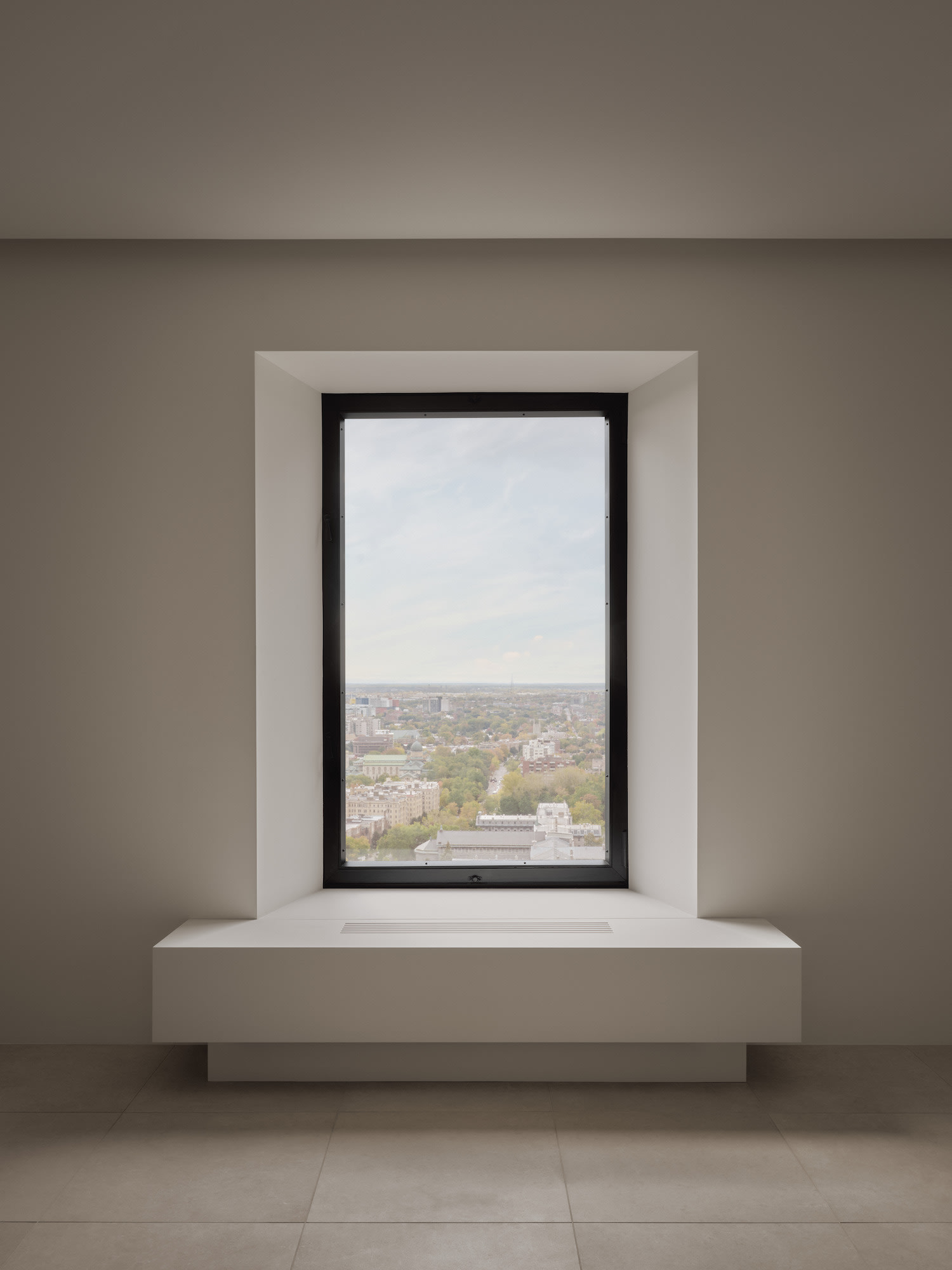 Modern apartment balcony with glass enclosure and city views