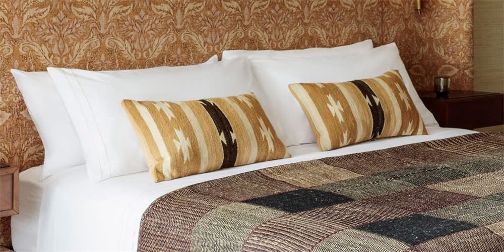 Boho living room with layered textiles and colorful cushions