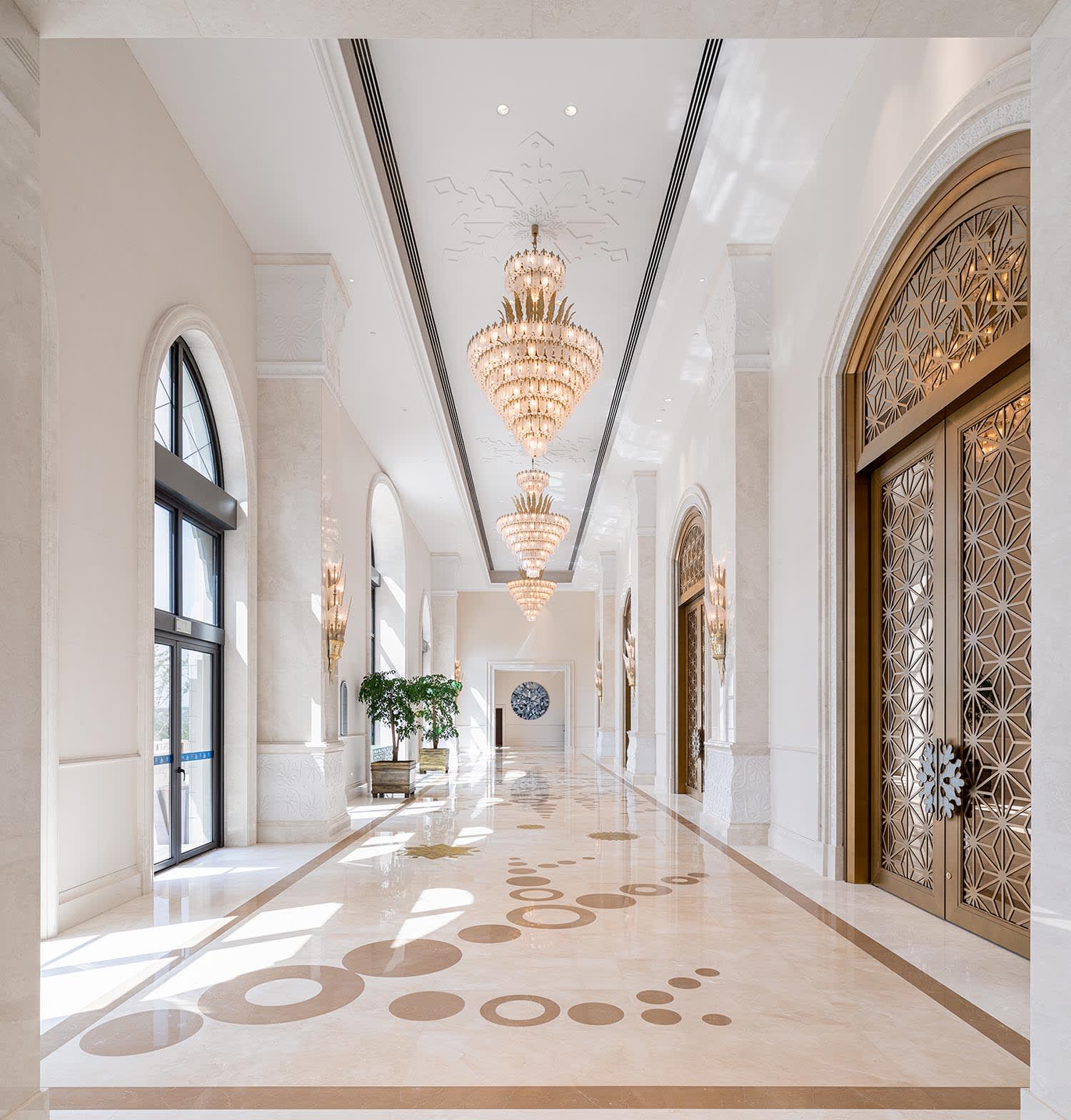 Luxury entryway featuring large ornate statement mirror with chandelier