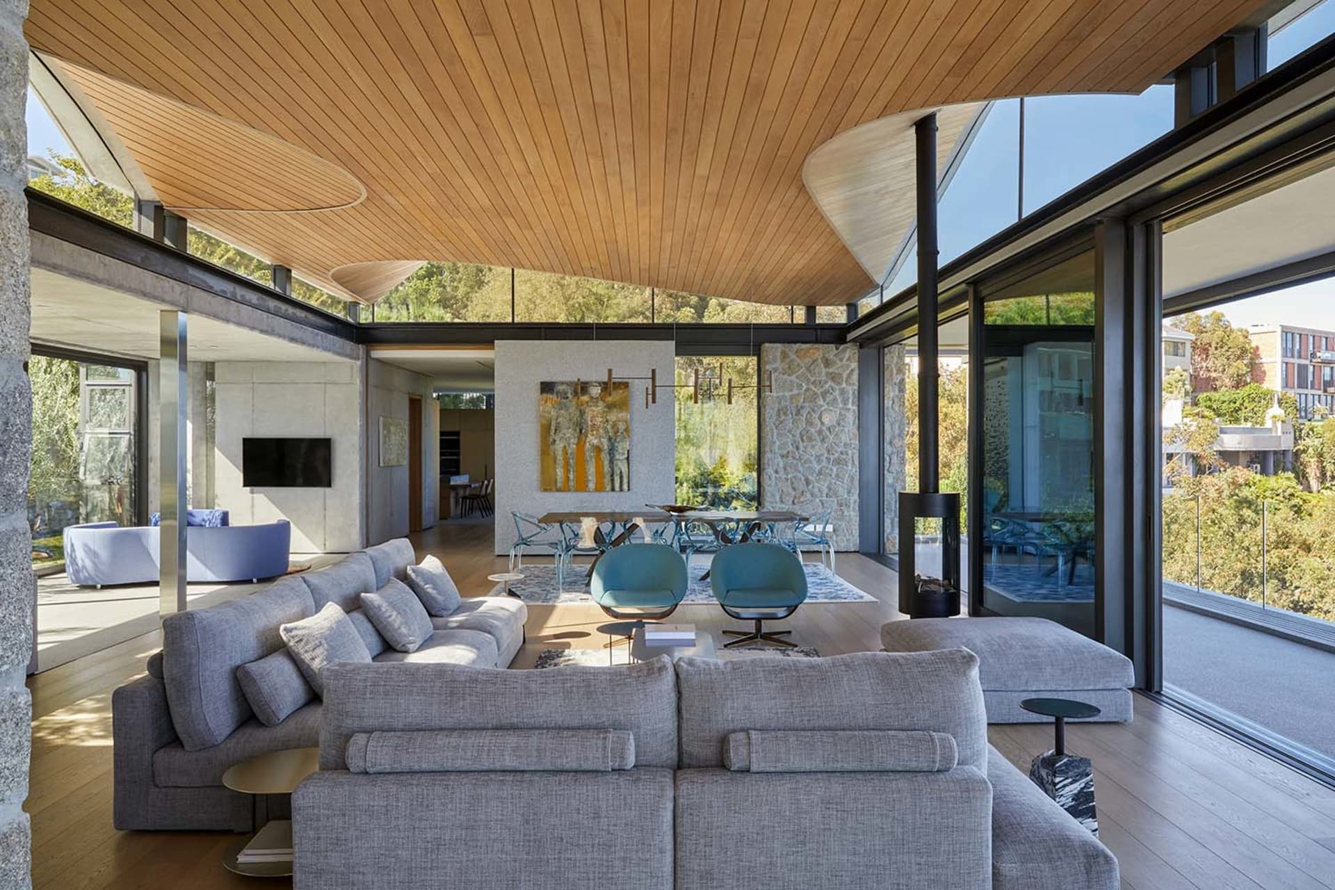 Modern minimalist living room featuring wood, concrete, and glass materials.