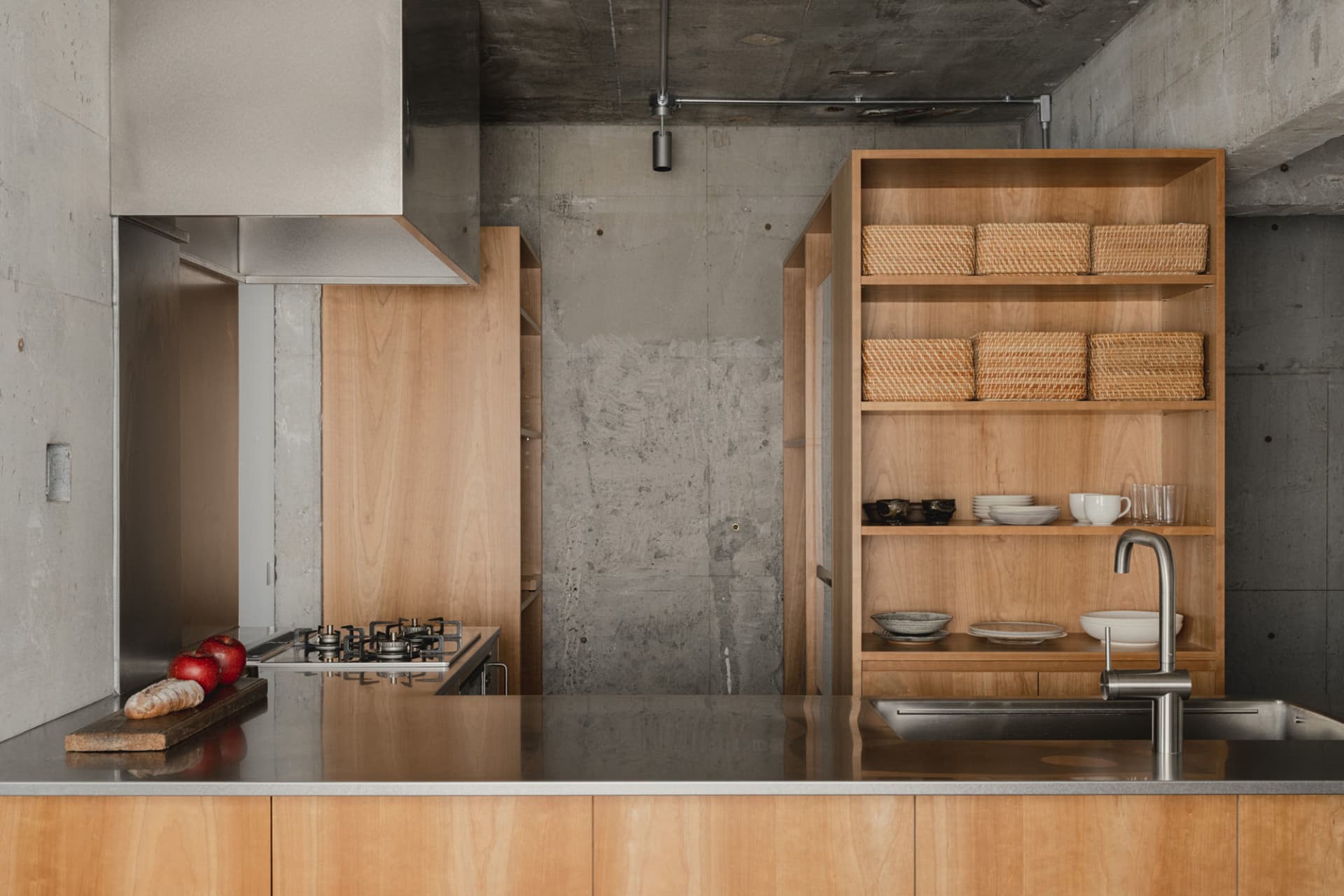 Modern industrial kitchen with wood, concrete, and metal elements.