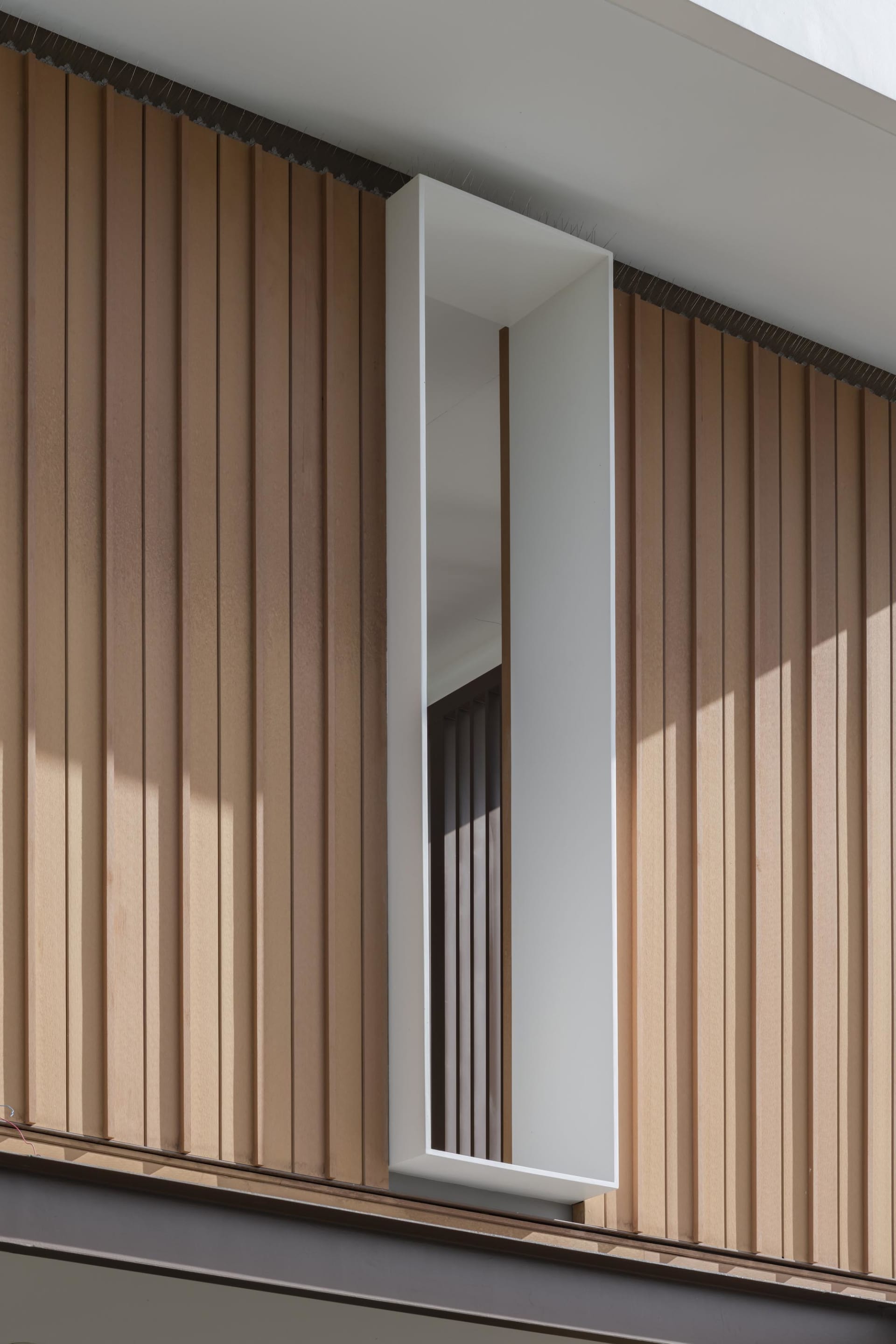 A modern interior space featuring wooden paneled walls.