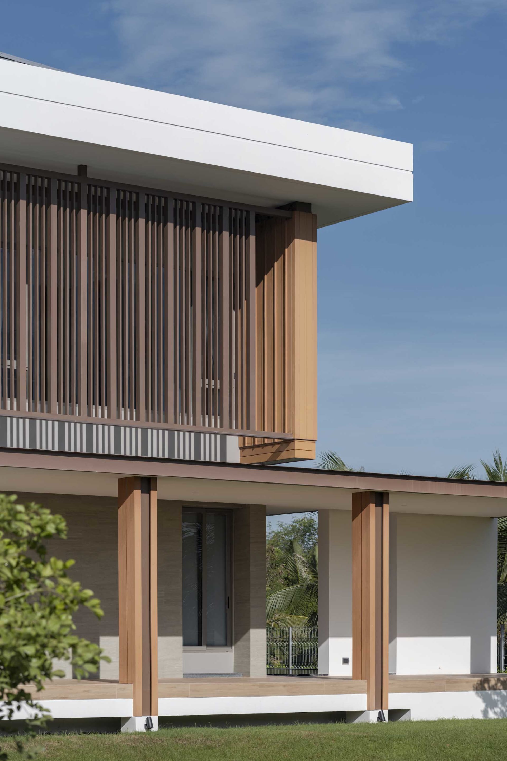 A modern residential exterior featuring concrete and wood materials.