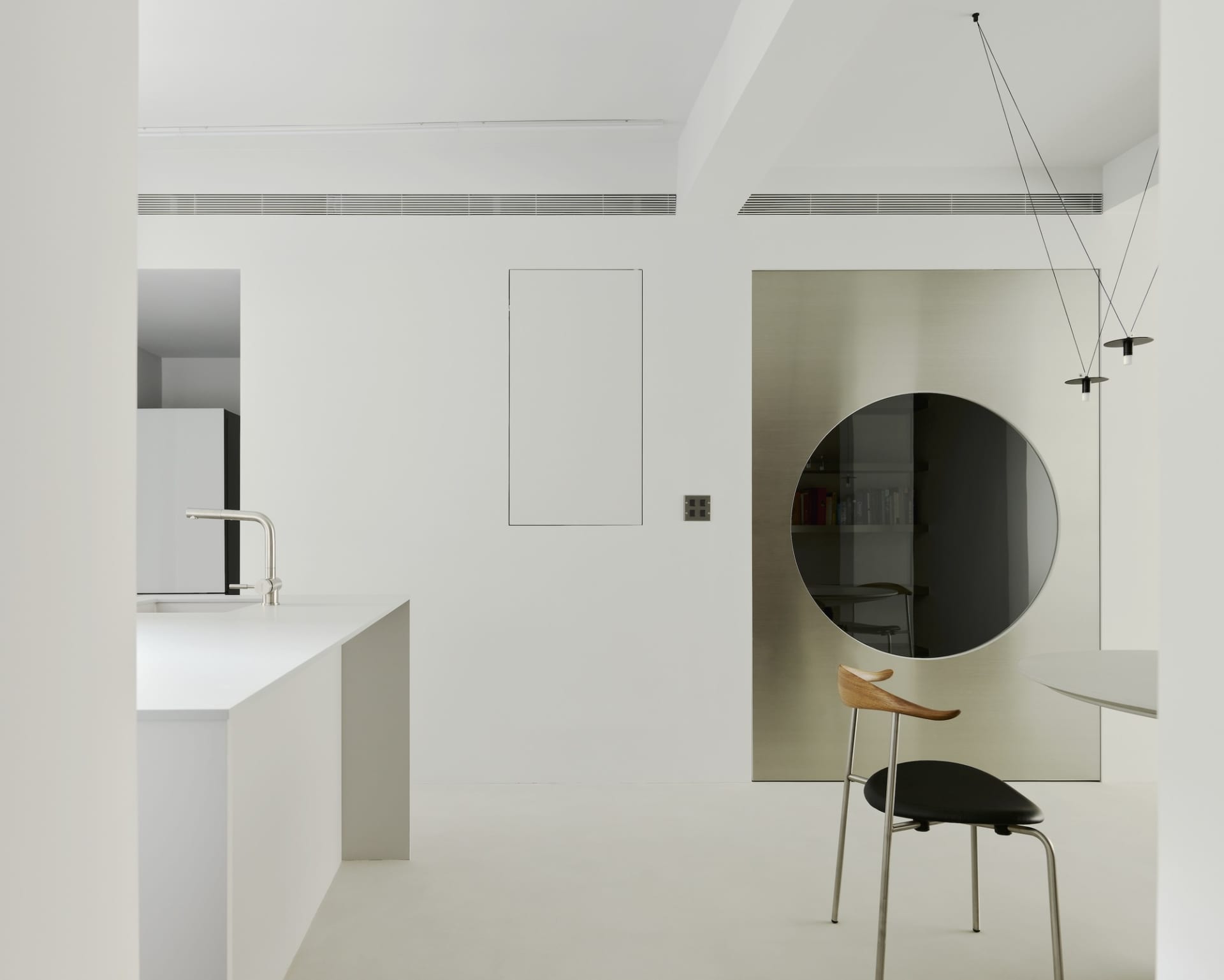 Modern minimalist kitchen with sleek white cabinets, glass backsplash, and metallic accents.