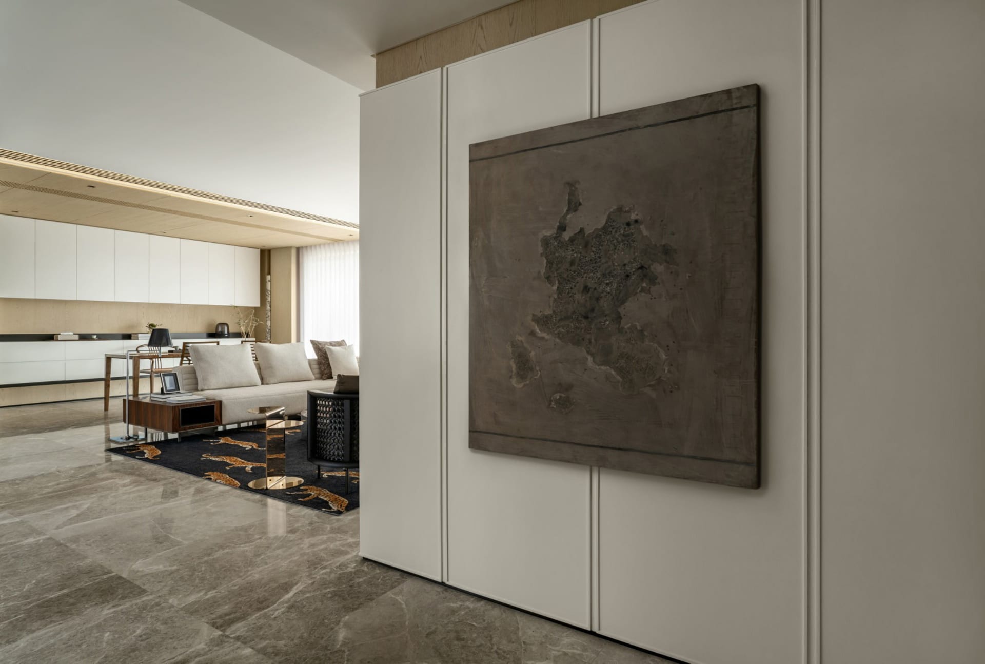 Modern living room featuring a metallic sculpture wall art.