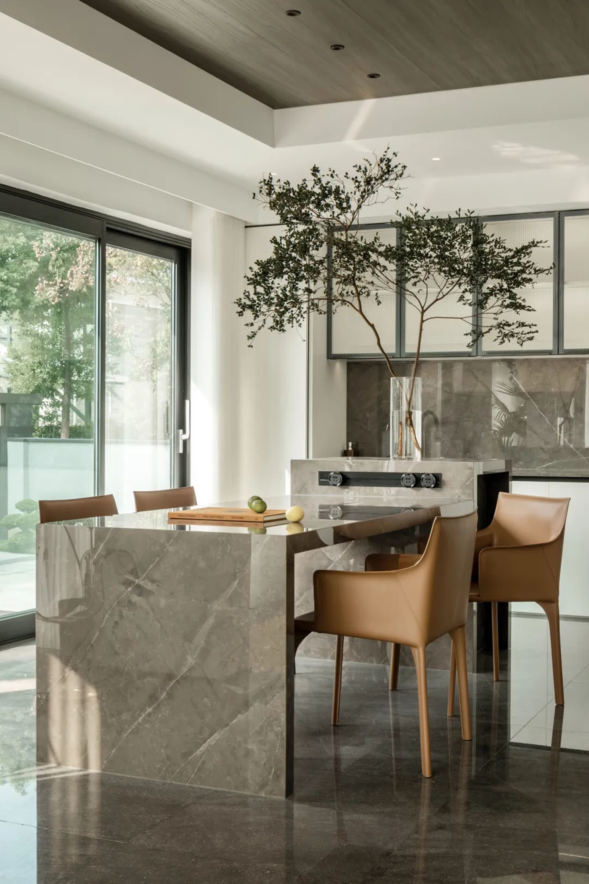 A modern kitchen with marble finishes and a minimalist design.