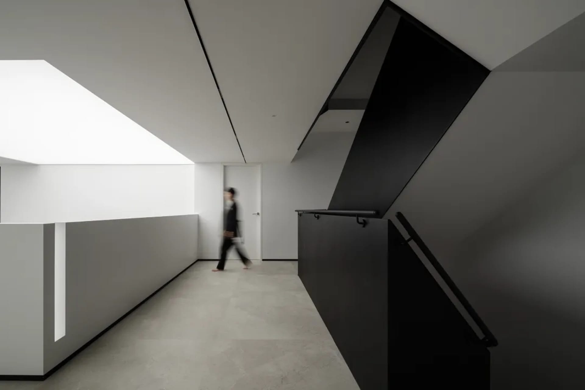 A modern office interior with concrete, glass, and metal elements