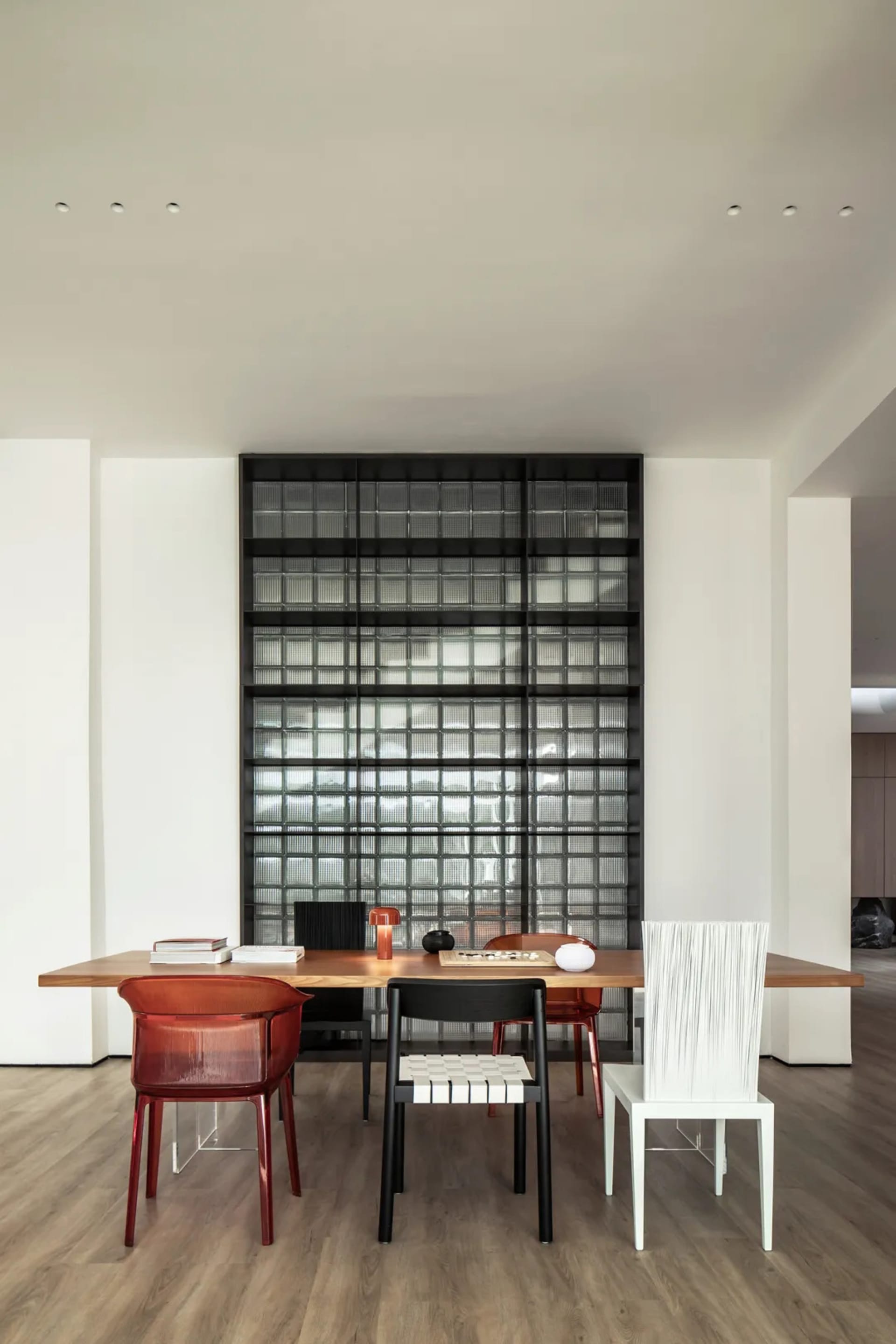 A modern office space featuring a wooden desk with various chairs.