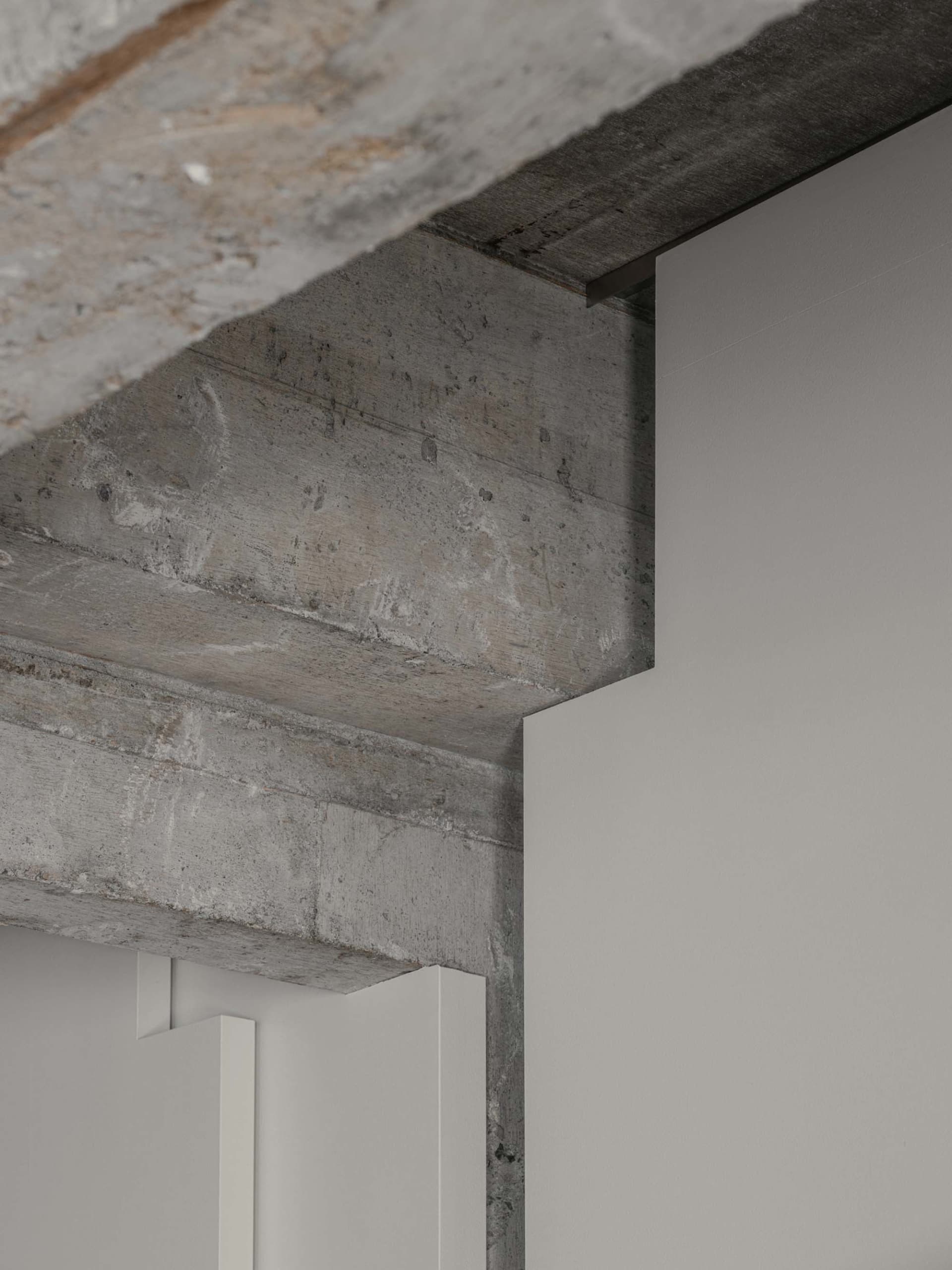 Industrial-style interior design featuring concrete walls and exposed beams