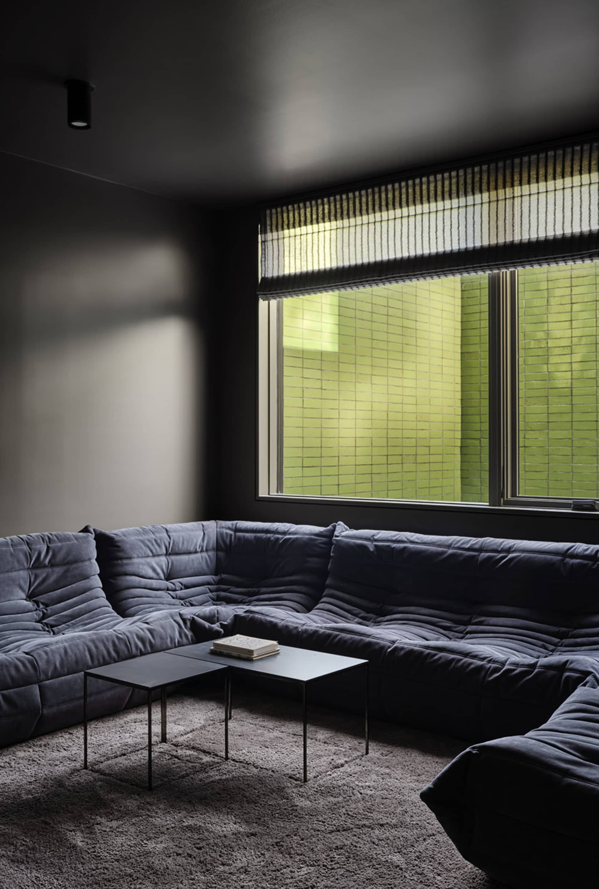 A modern living room featuring a fabric sectional sofa.