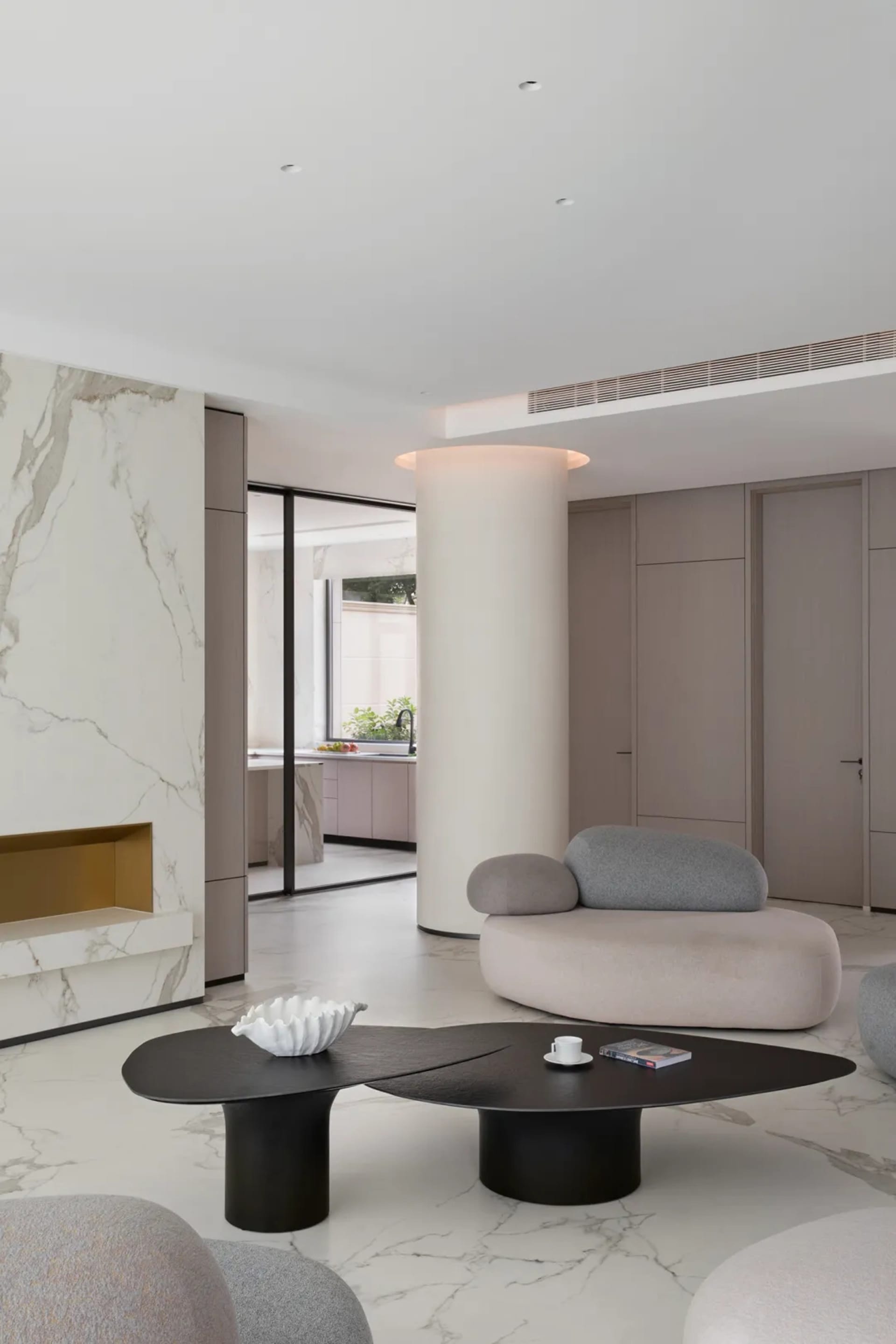 Modern living room with marble accents and a minimalist design.