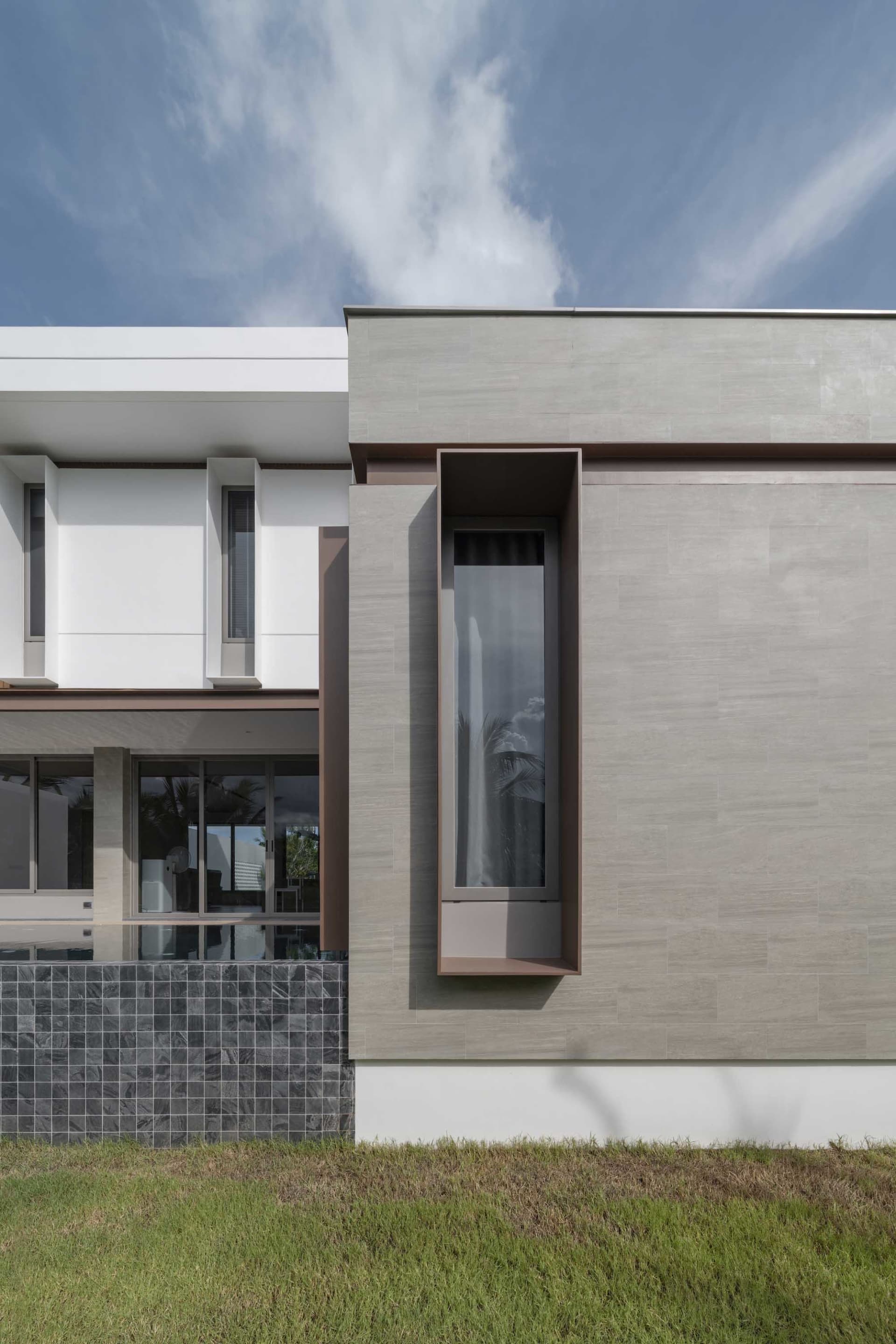 A modern residential building with concrete and glass materials.