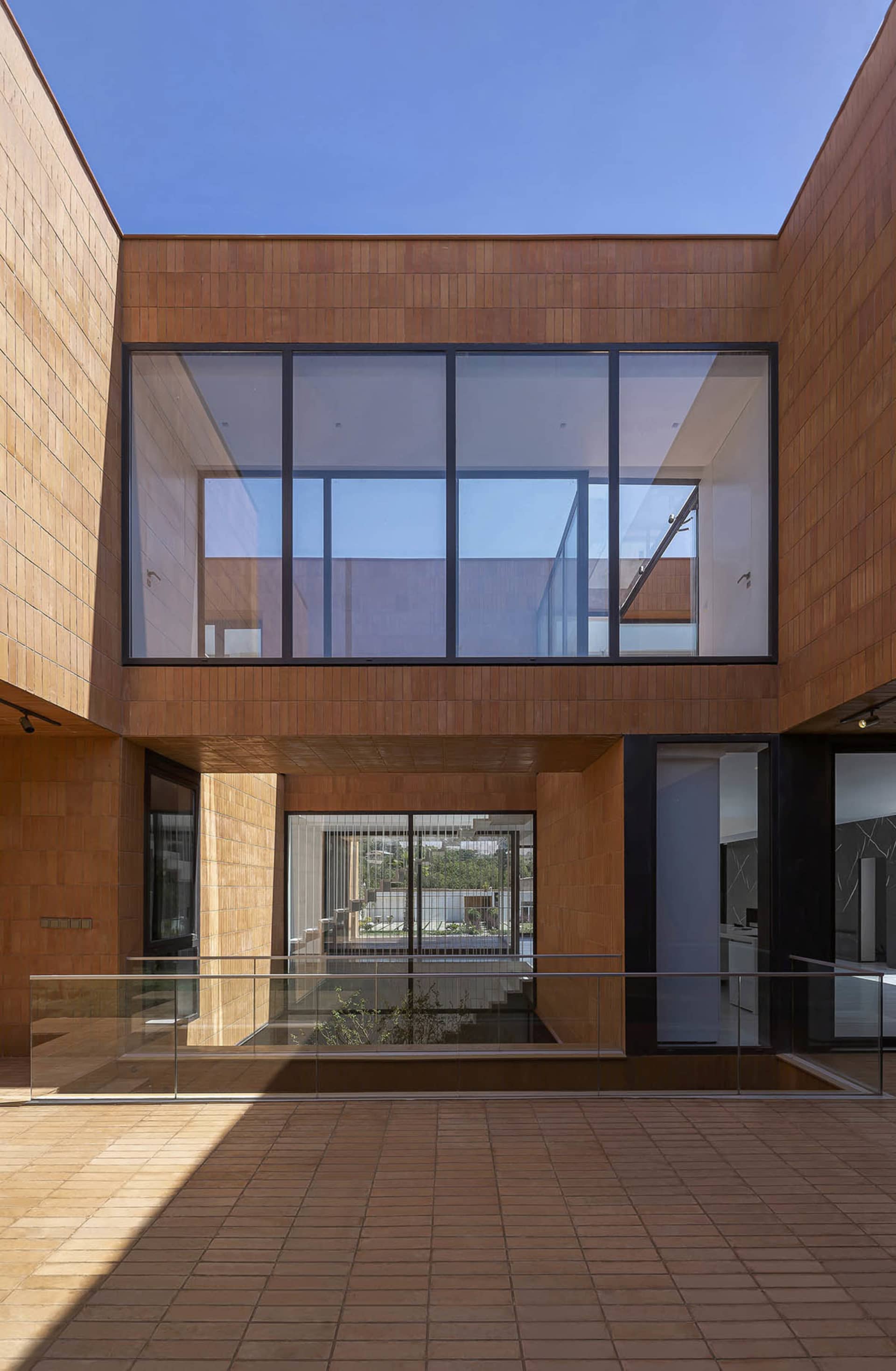 Modern building exterior made of wooden materials with large glass windows.