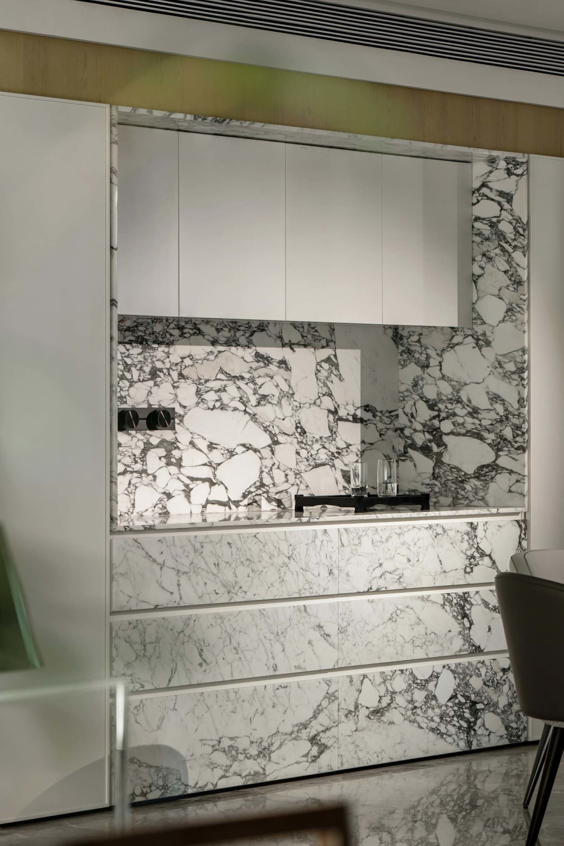 Modern kitchen with marble walls and countertop