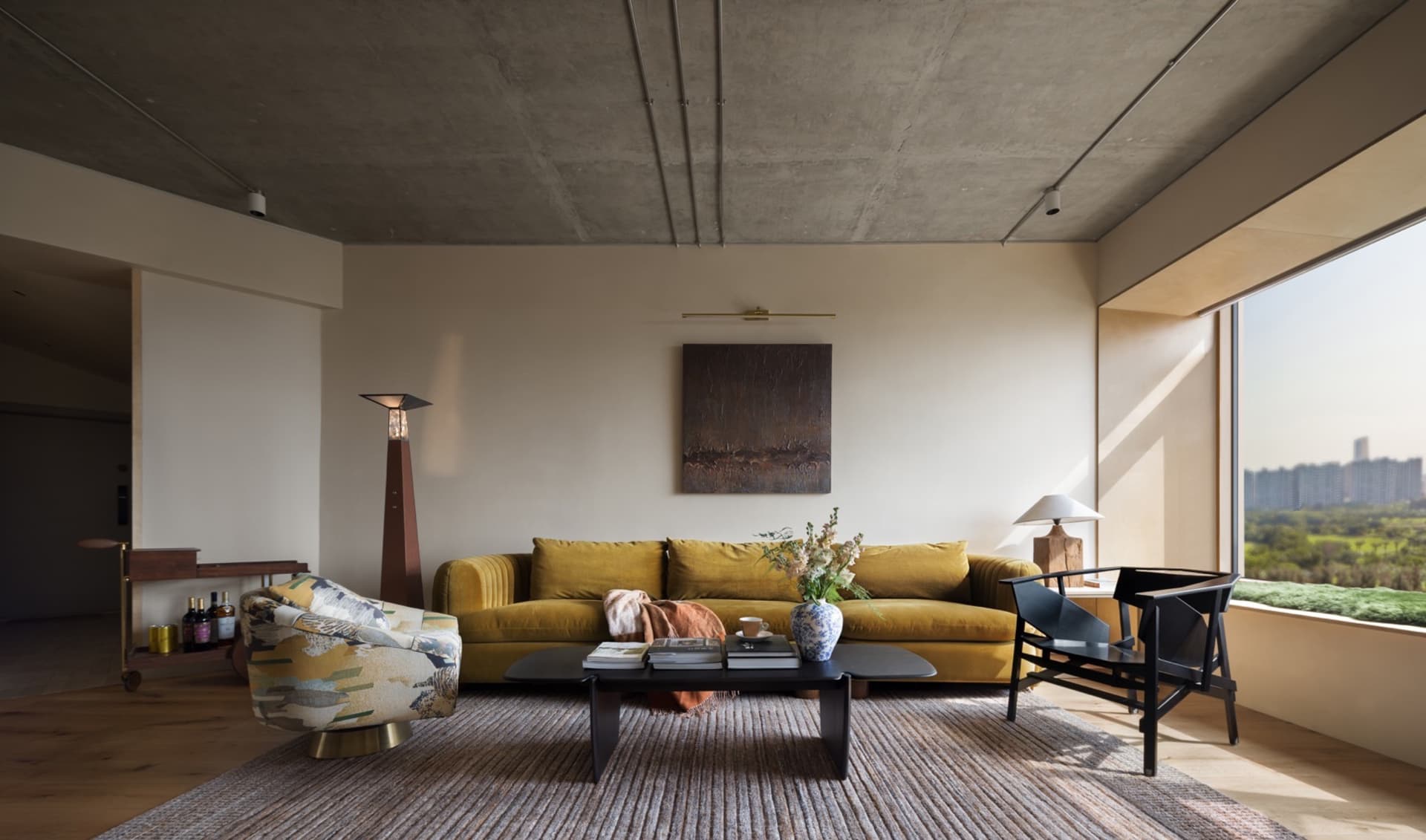 Modern living room featuring concrete, wood, and glass materials.