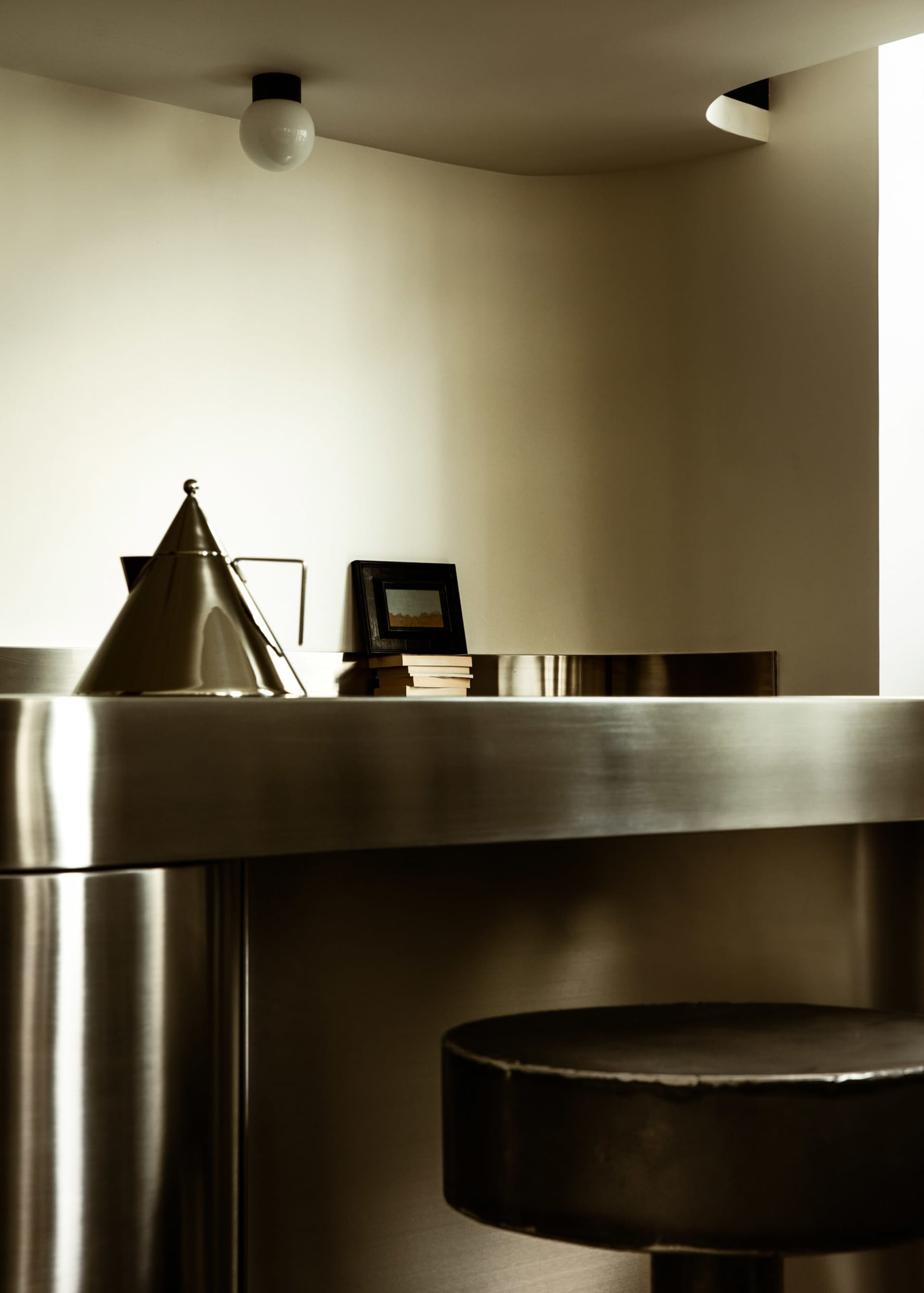 A sleek, minimalist kitchen with metallic finishes and a modern design.