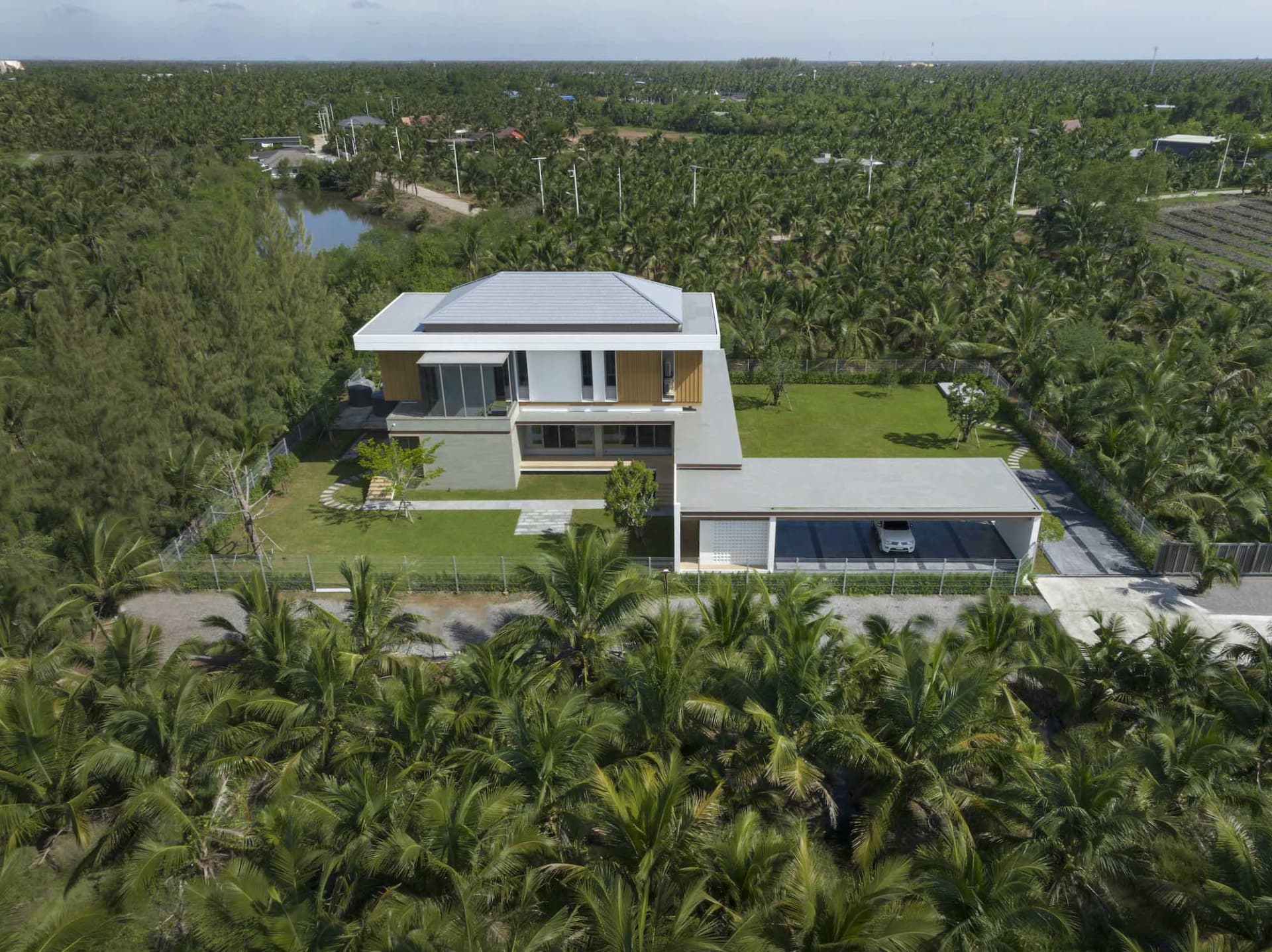 Modern residential house with a combination of concrete and glass exterior materials.