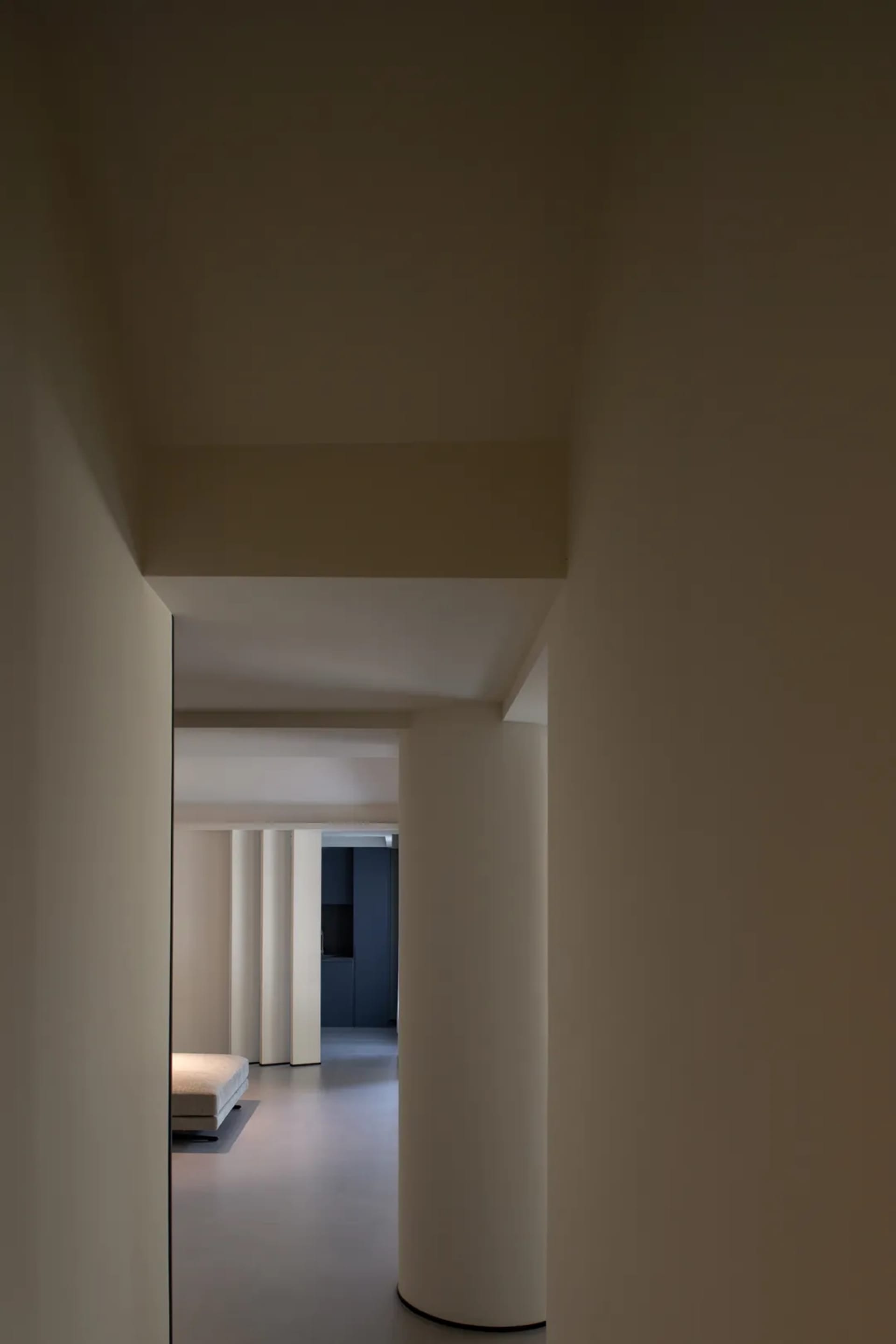 A modern interior space featuring concrete columns and minimalistic design.