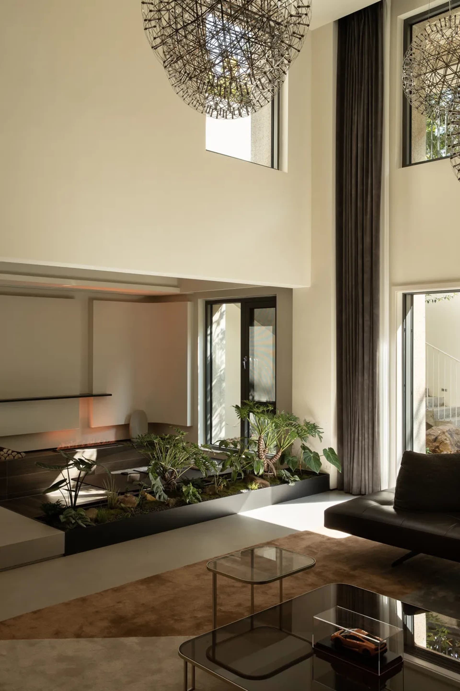 Modern living room featuring concrete, glass, and metal materials.