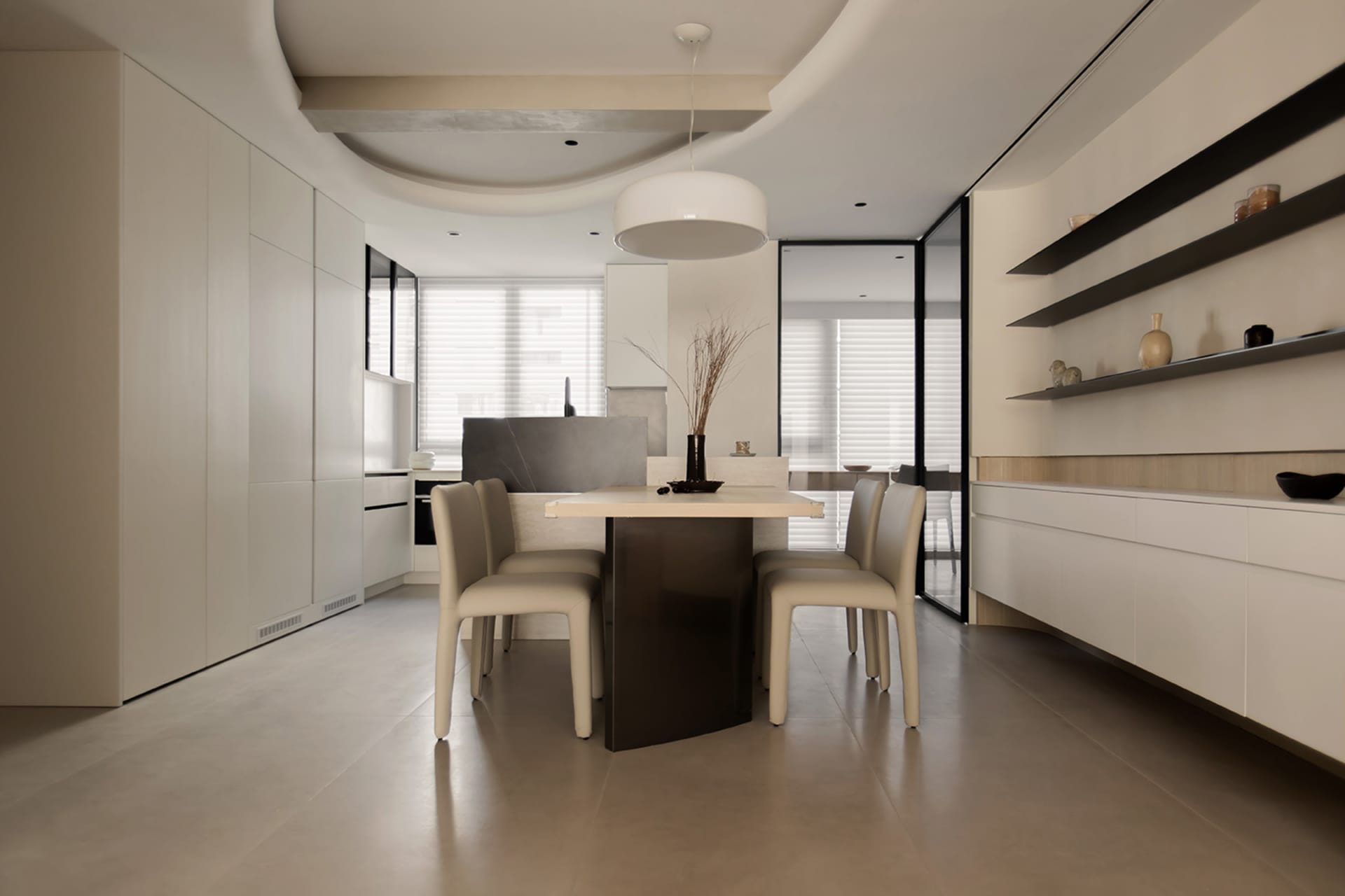 Modern kitchen and dining area with concrete cabinets, minimalist furniture, and sleek design elements.