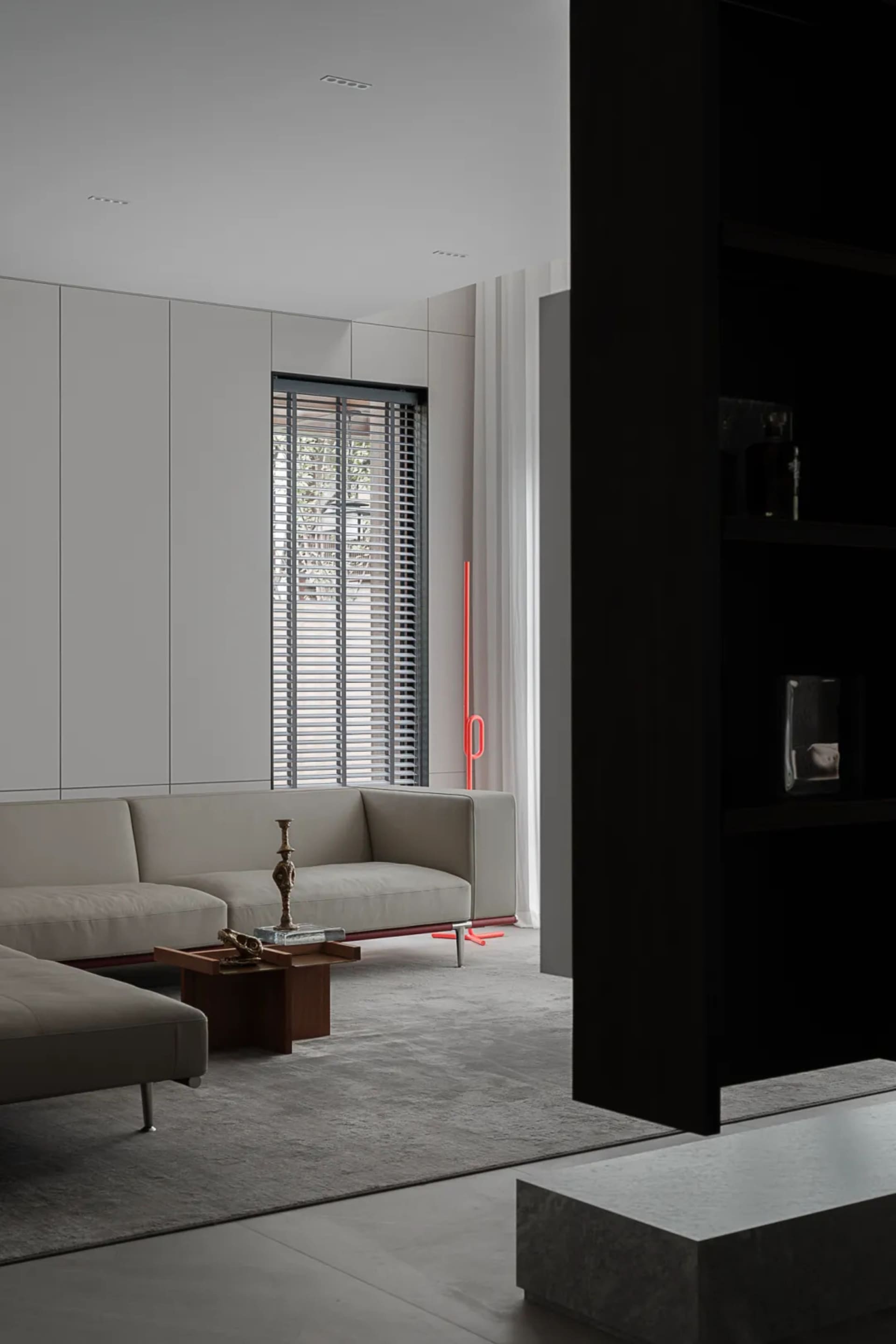 Modern living room with minimalist design, featuring shades of grey and concrete materials, showcasing sleek, contemporary fu