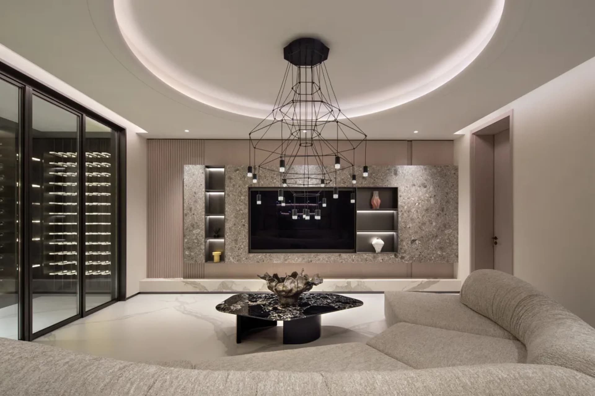 A modern living room featuring marble surfaces, glass panels, and metallic accents.