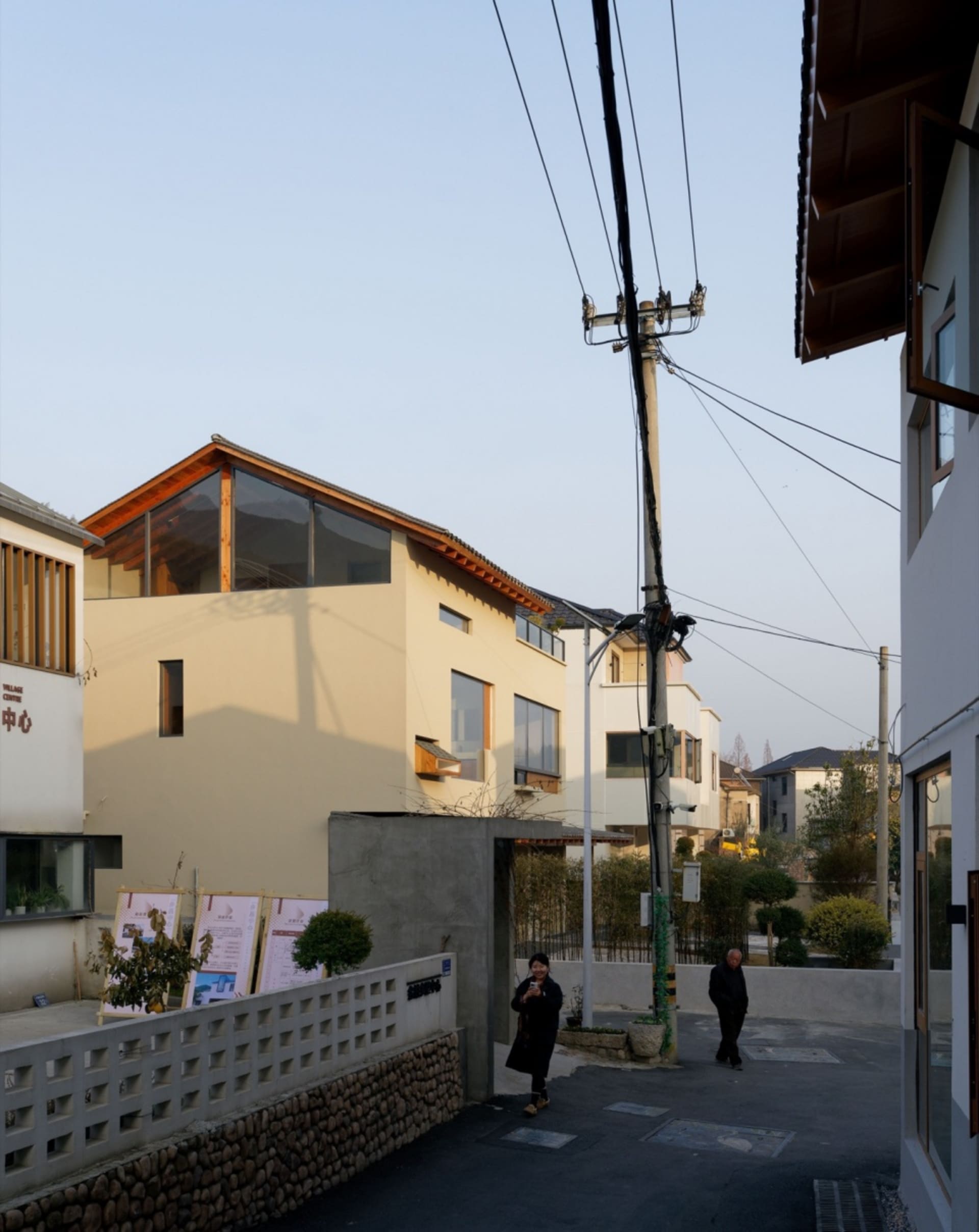 Modern residential neighborhood with concrete, glass, and wood exteriors.