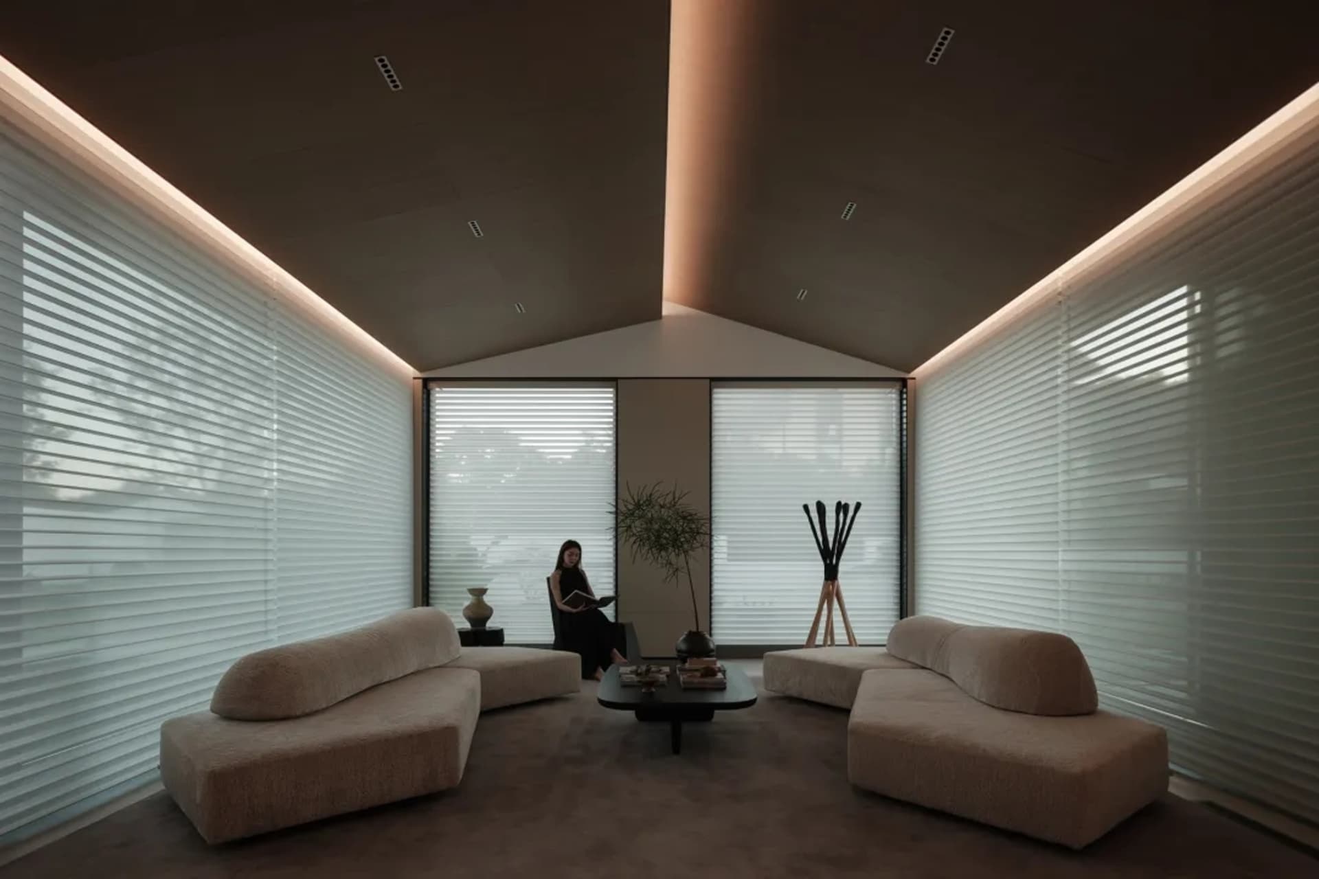 A modern living room with beige upholstered furniture.