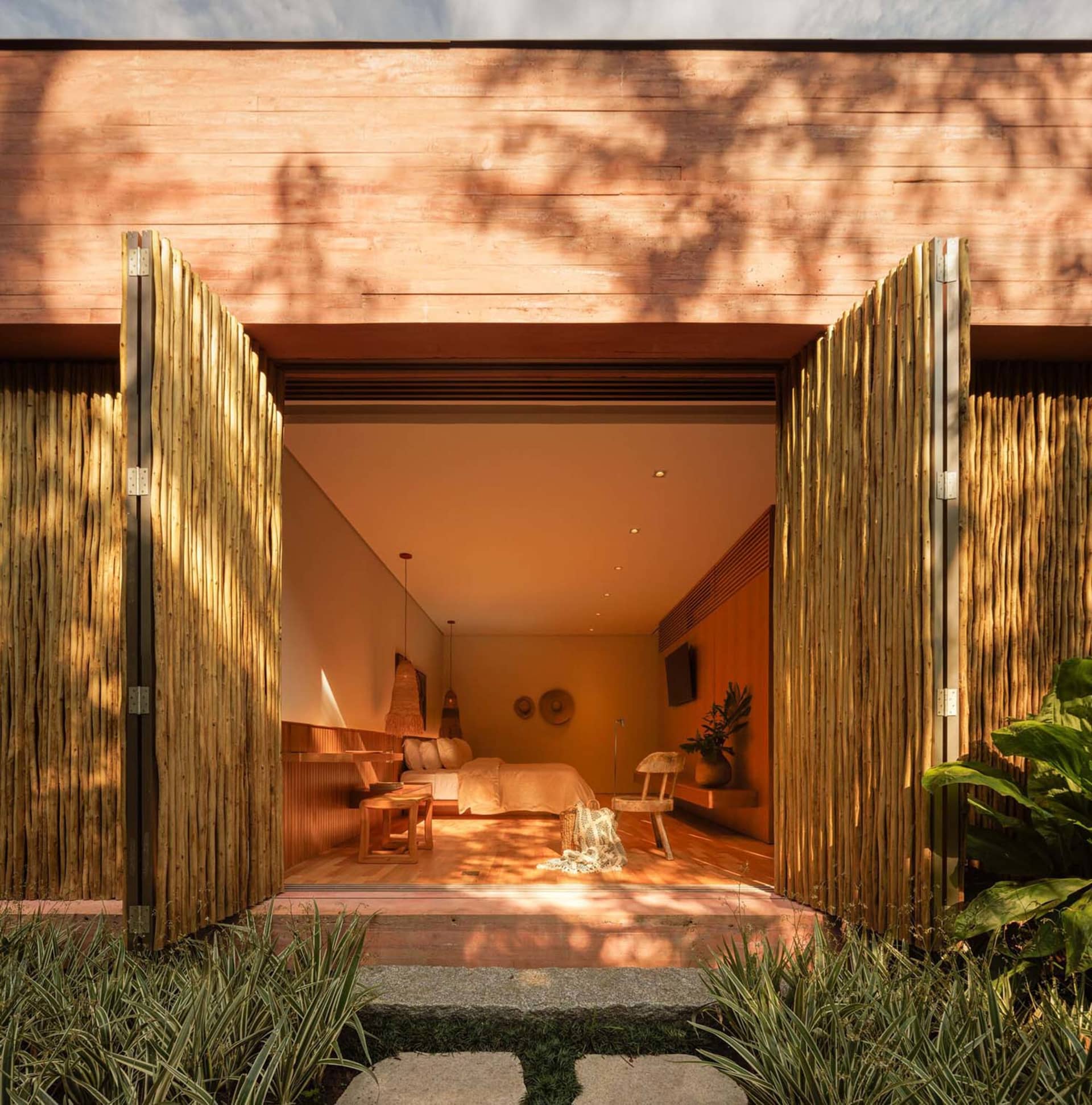A bohemian-style bedroom with wooden panels made of bamboo.