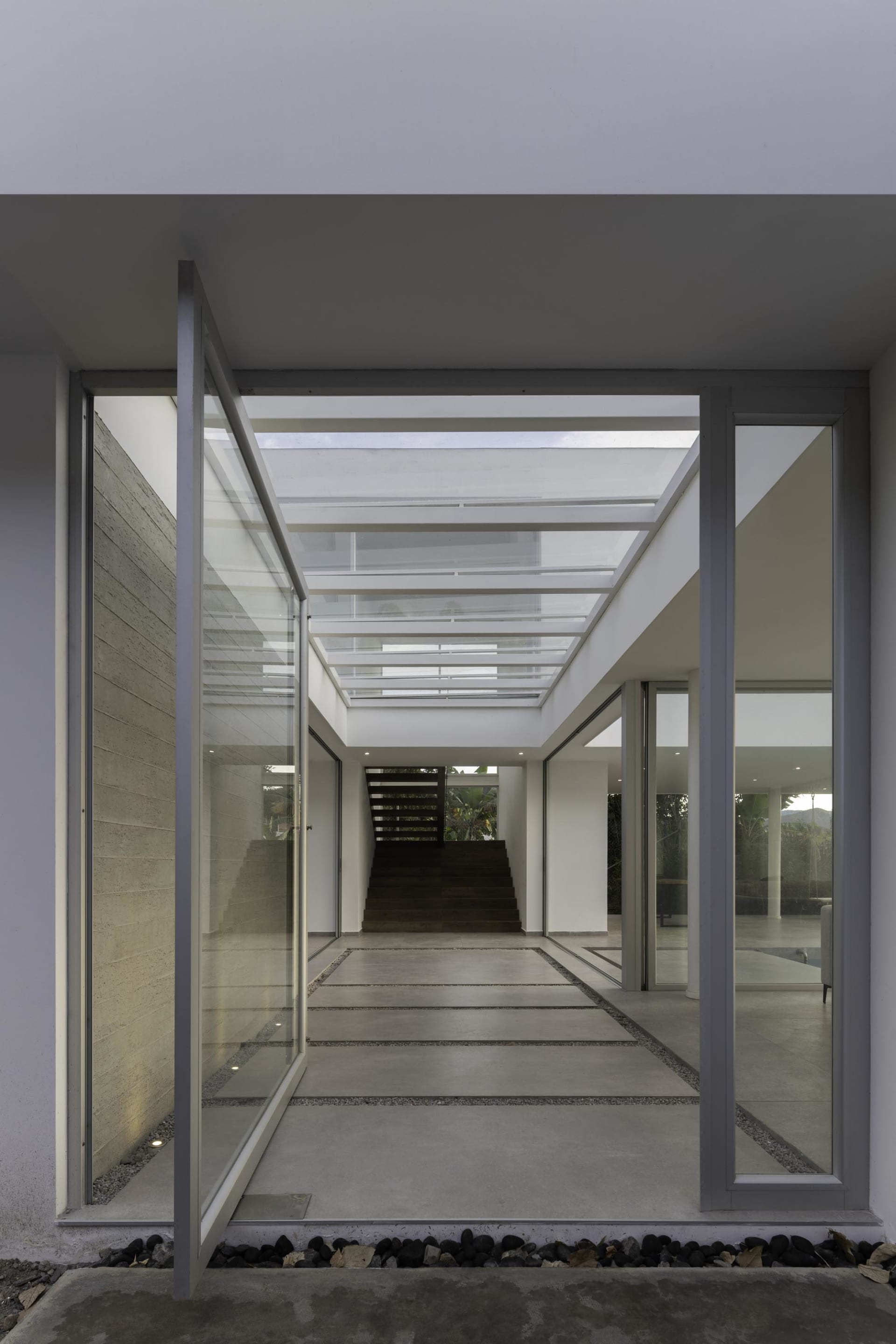 Modern residential interior featuring concrete flooring and a skylight.