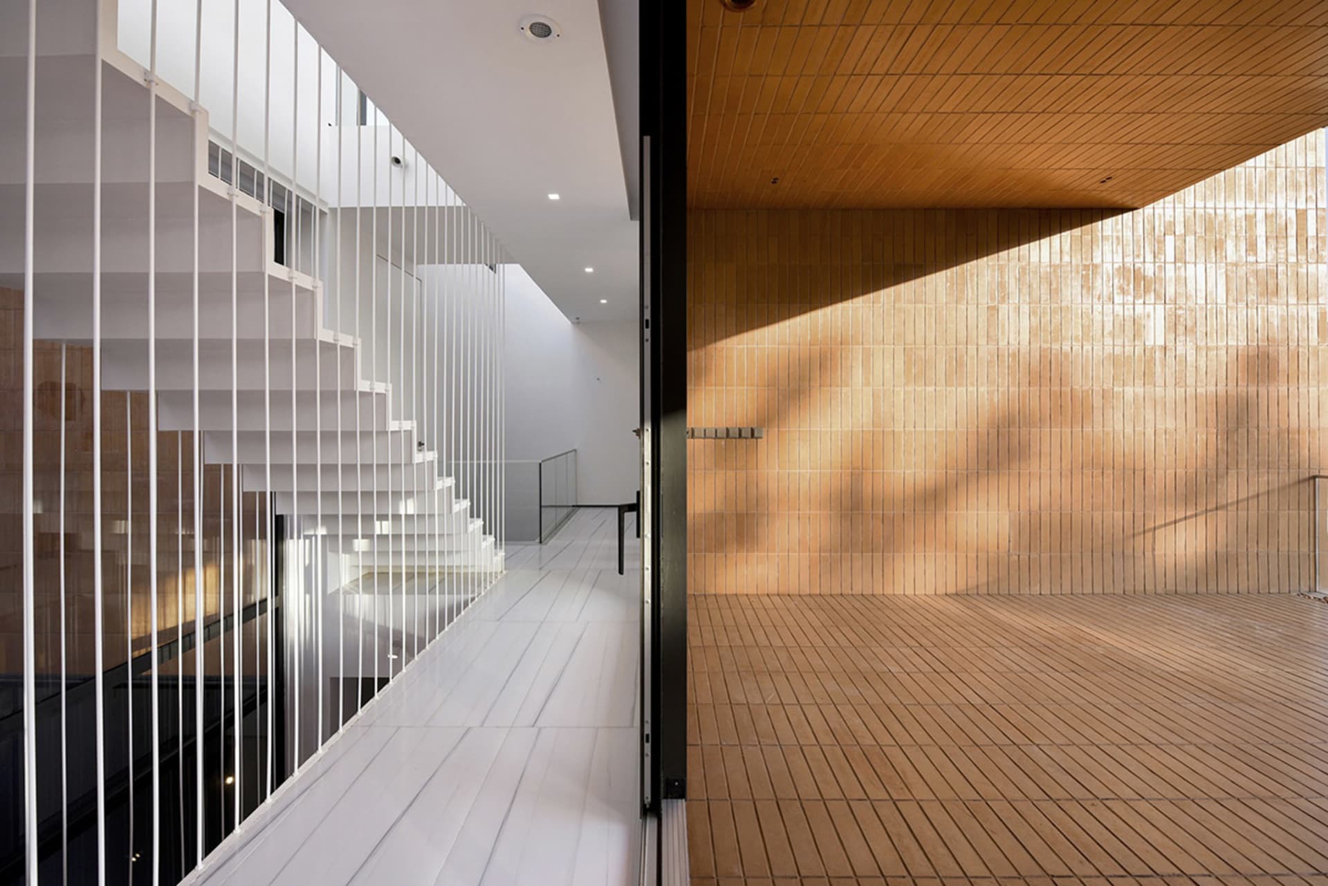 A modern interior featuring wooden tiles and stairs.