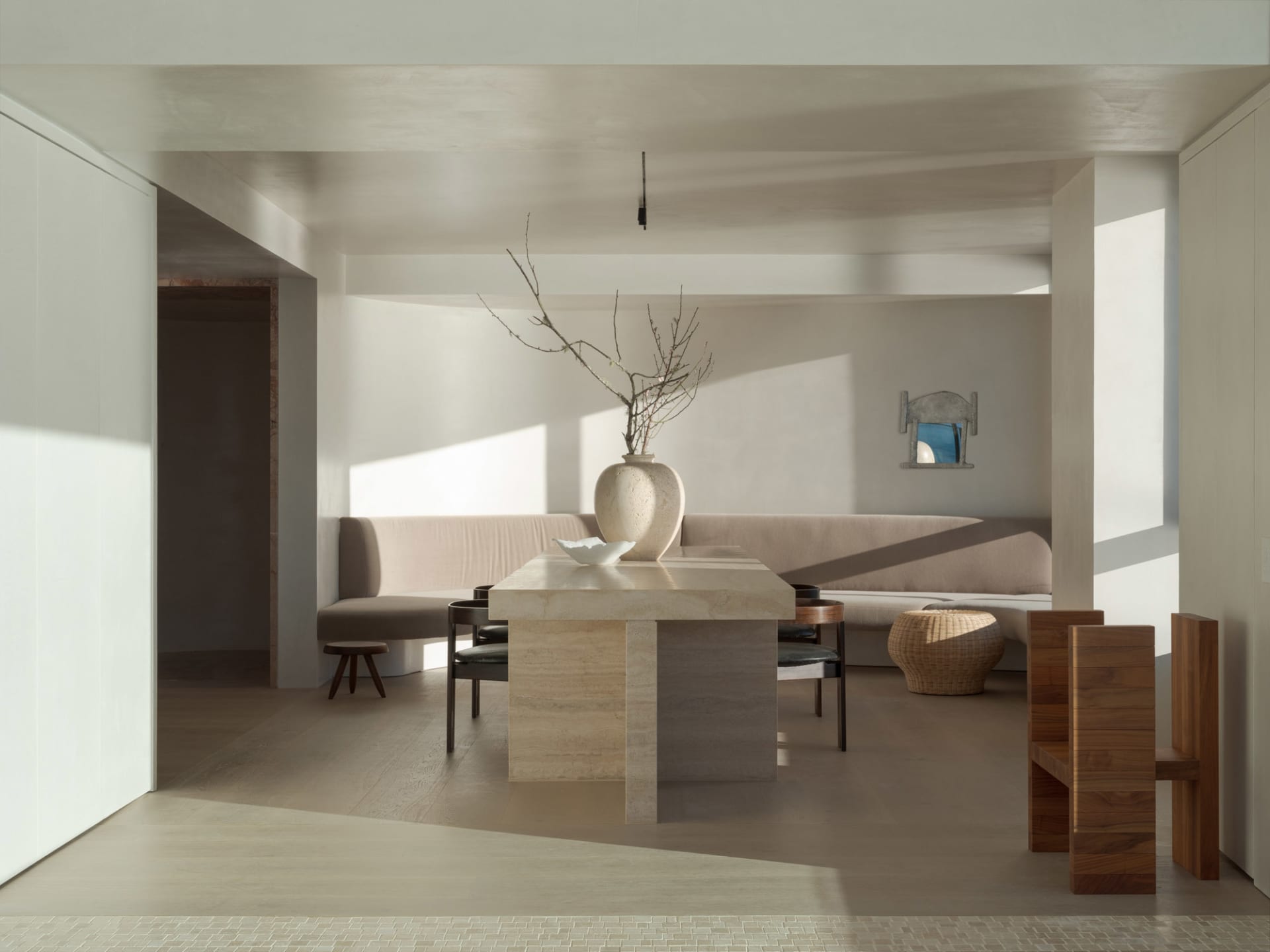 A modern minimalist living room with a neutral color palette featuring minimal furniture and design.
