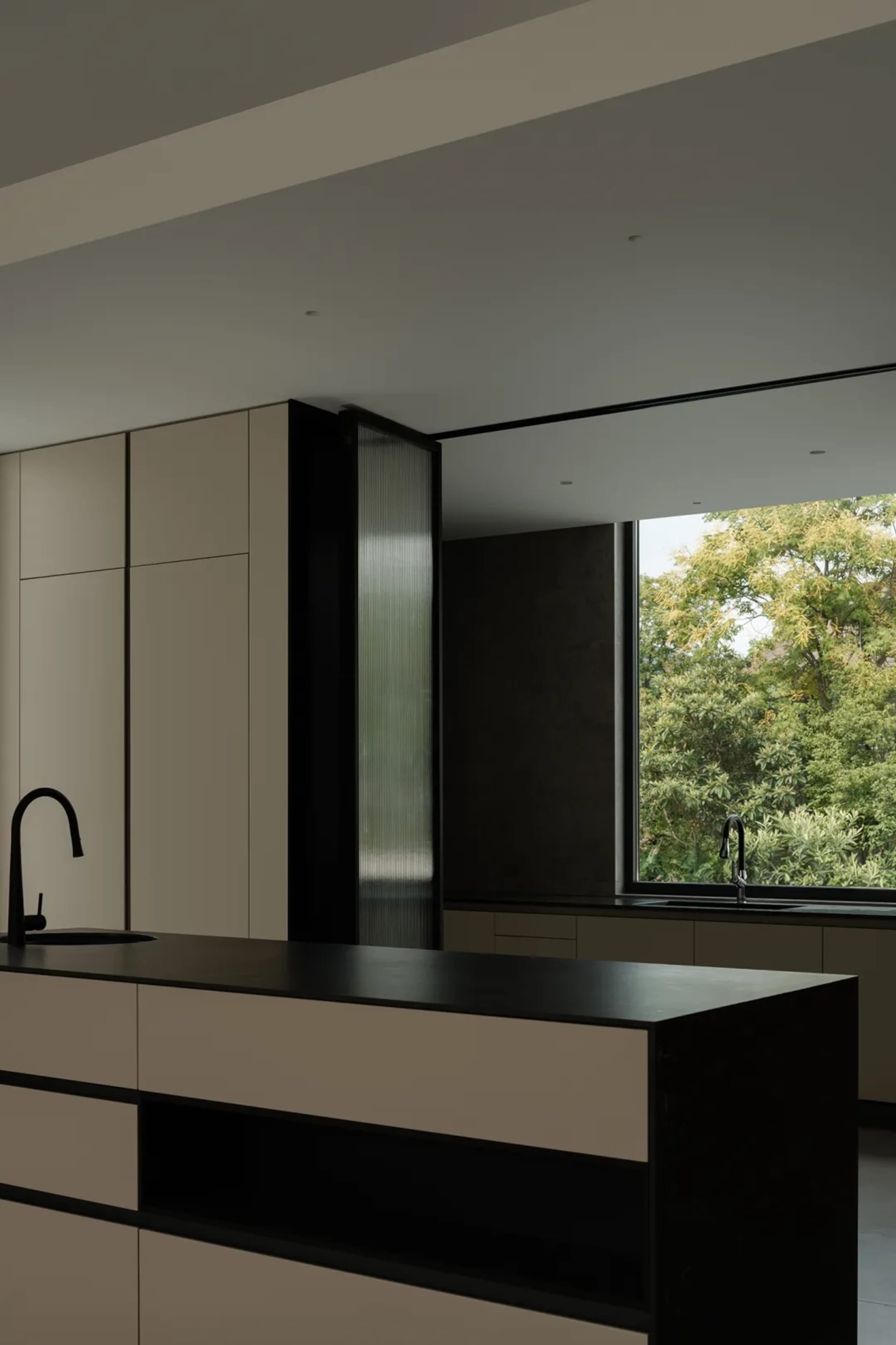 Modern kitchen featuring concrete, glass, metal, and wood elements