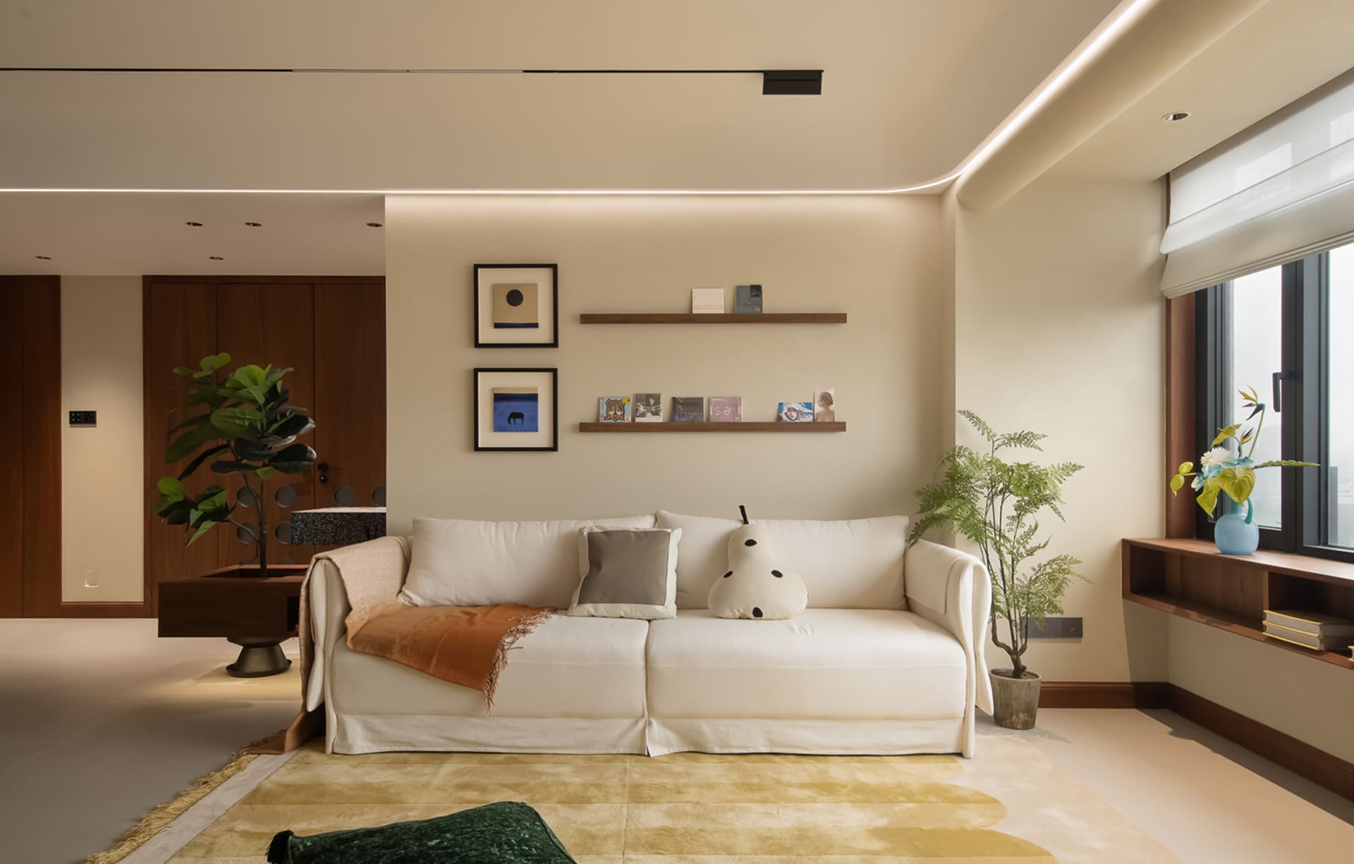 A modern living room featuring neutral-toned furniture and minimalist decor.