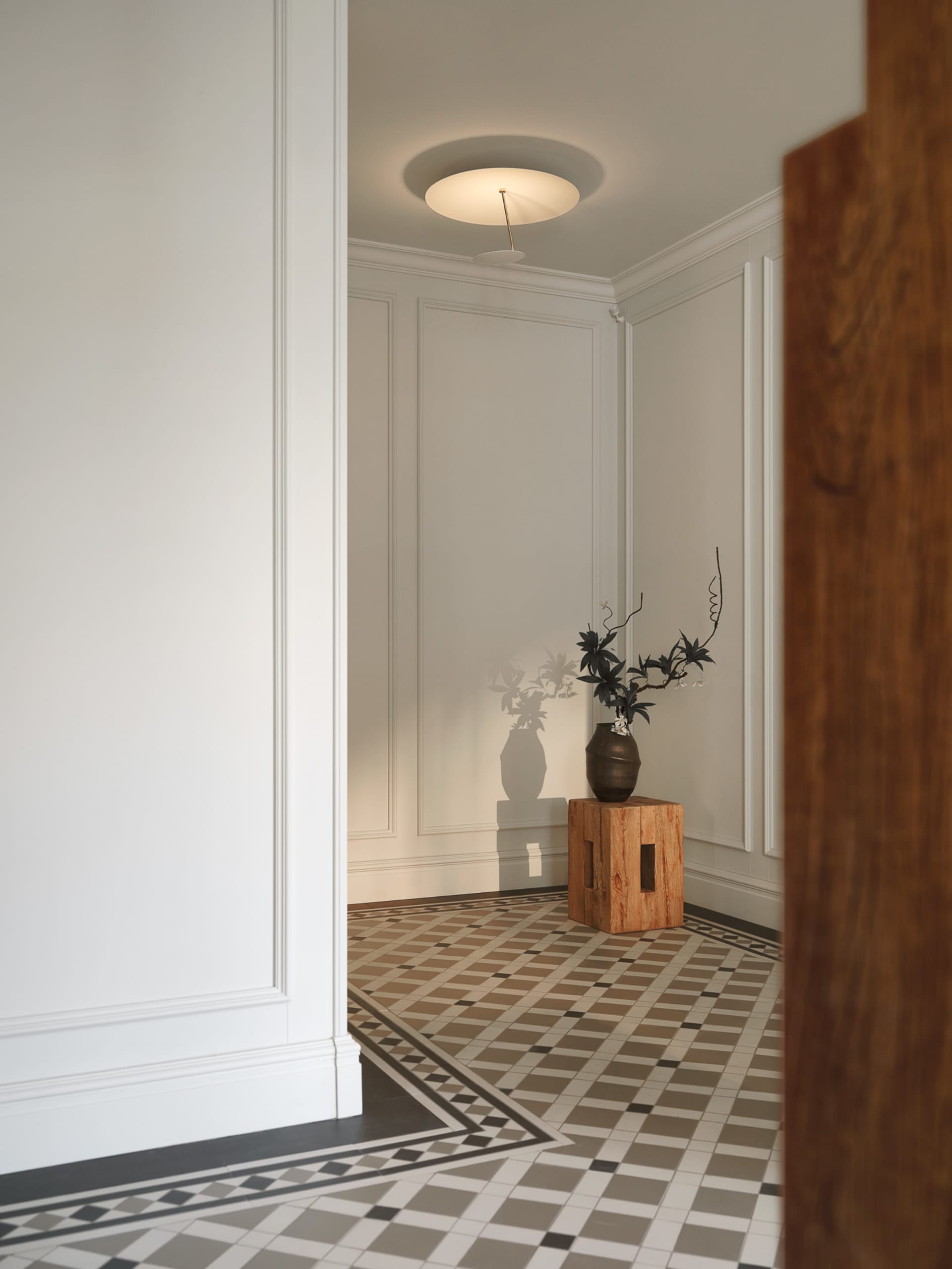 Entrance featuring modern minimalist design with tiled floor and wooden elements.