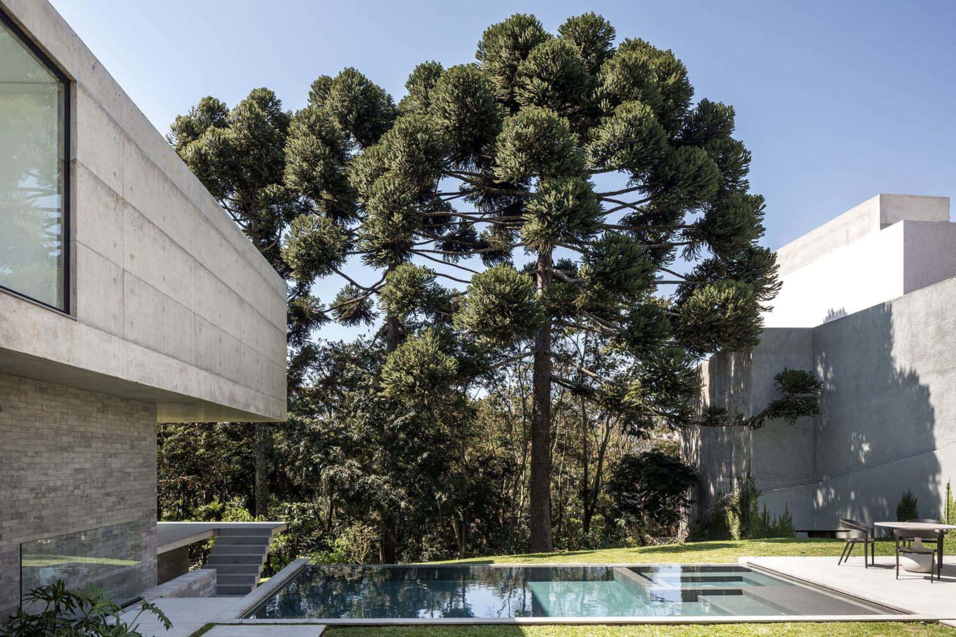 A modern landscape design featuring concrete structures and natural elements.