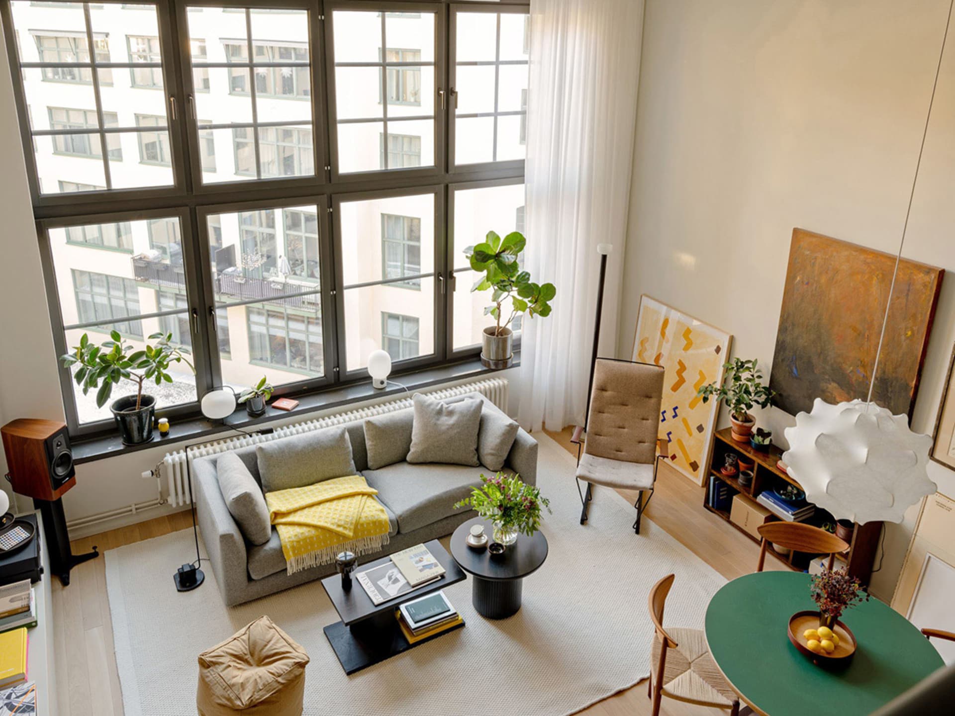 Contemporary living room with modernist furniture and plants.