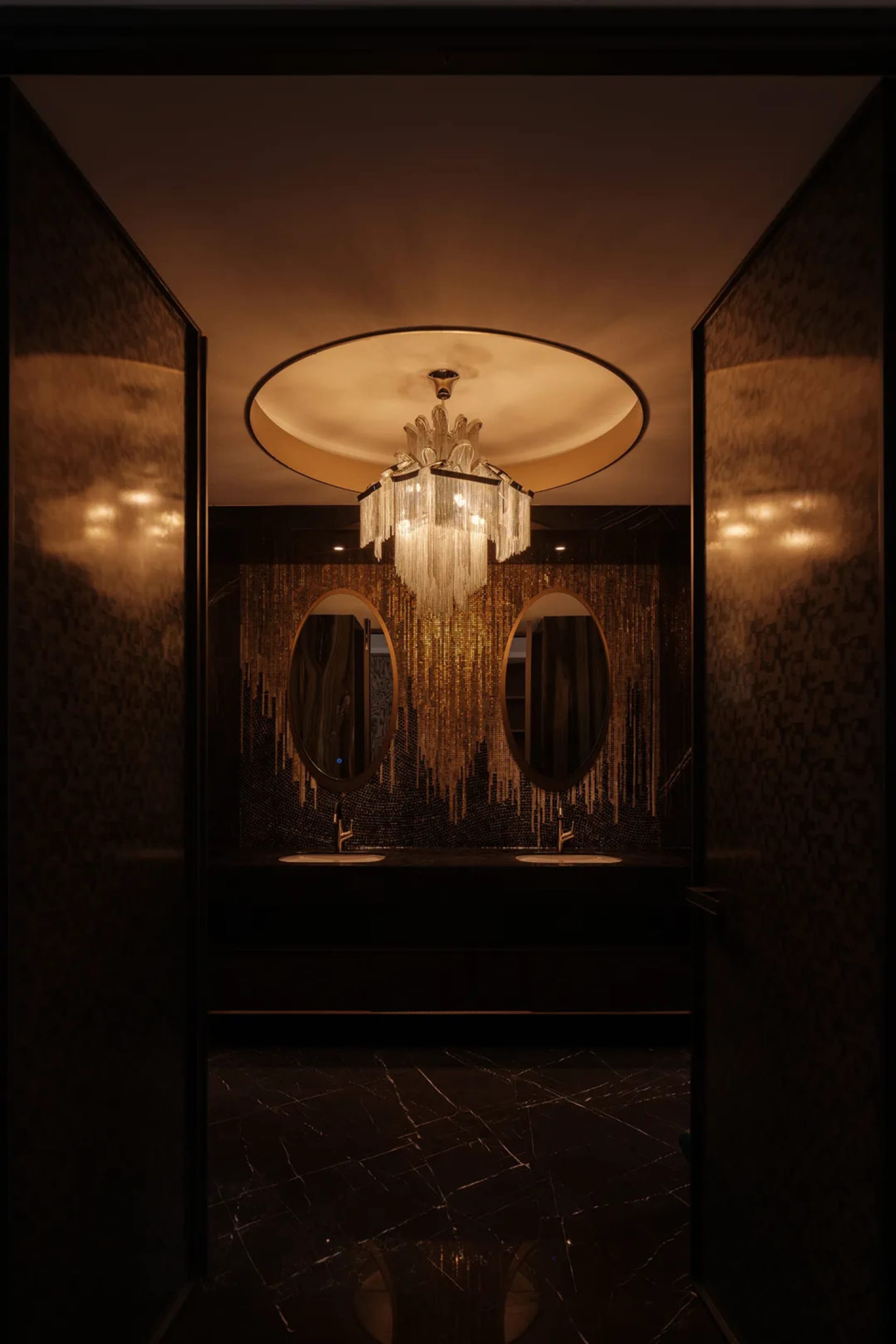 Interior of a modern bathroom featuring a luxurious chandelier and marble finishes.