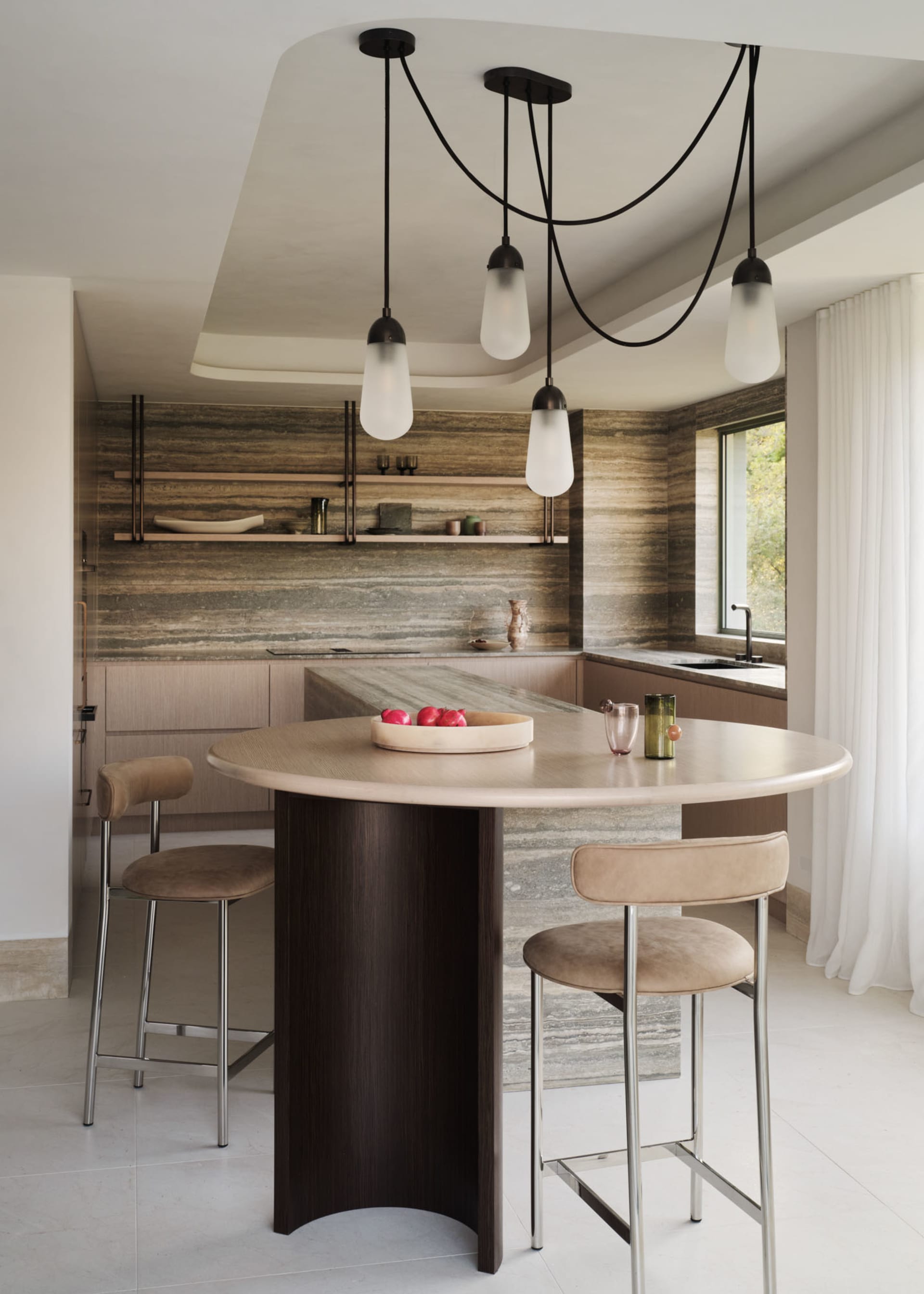 Modern minimalist kitchen with marble countertops and stainless steel appliances.