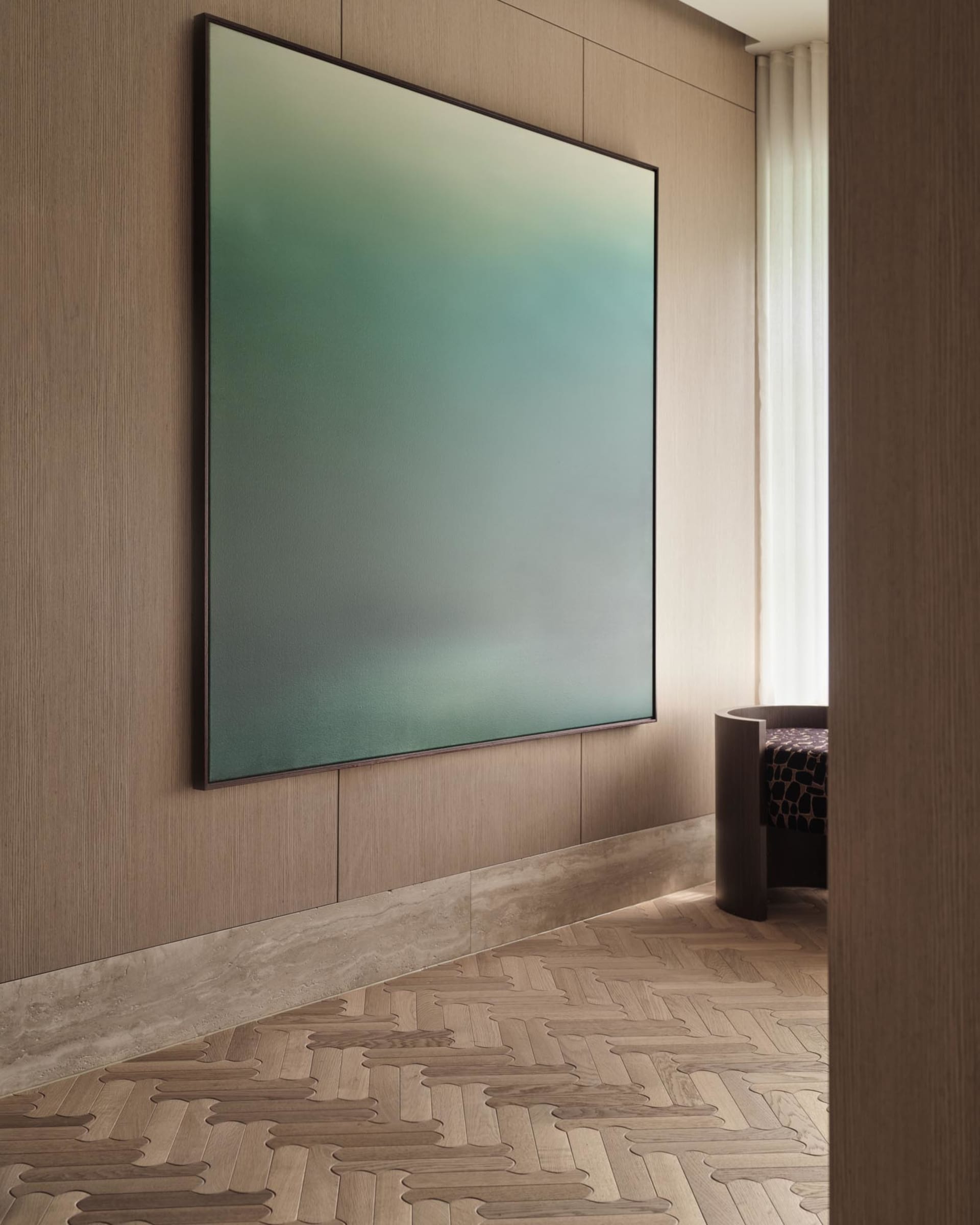 Modern minimalist living room featuring a large framed abstract painting in shades of green and blue, adorned with wooden pan